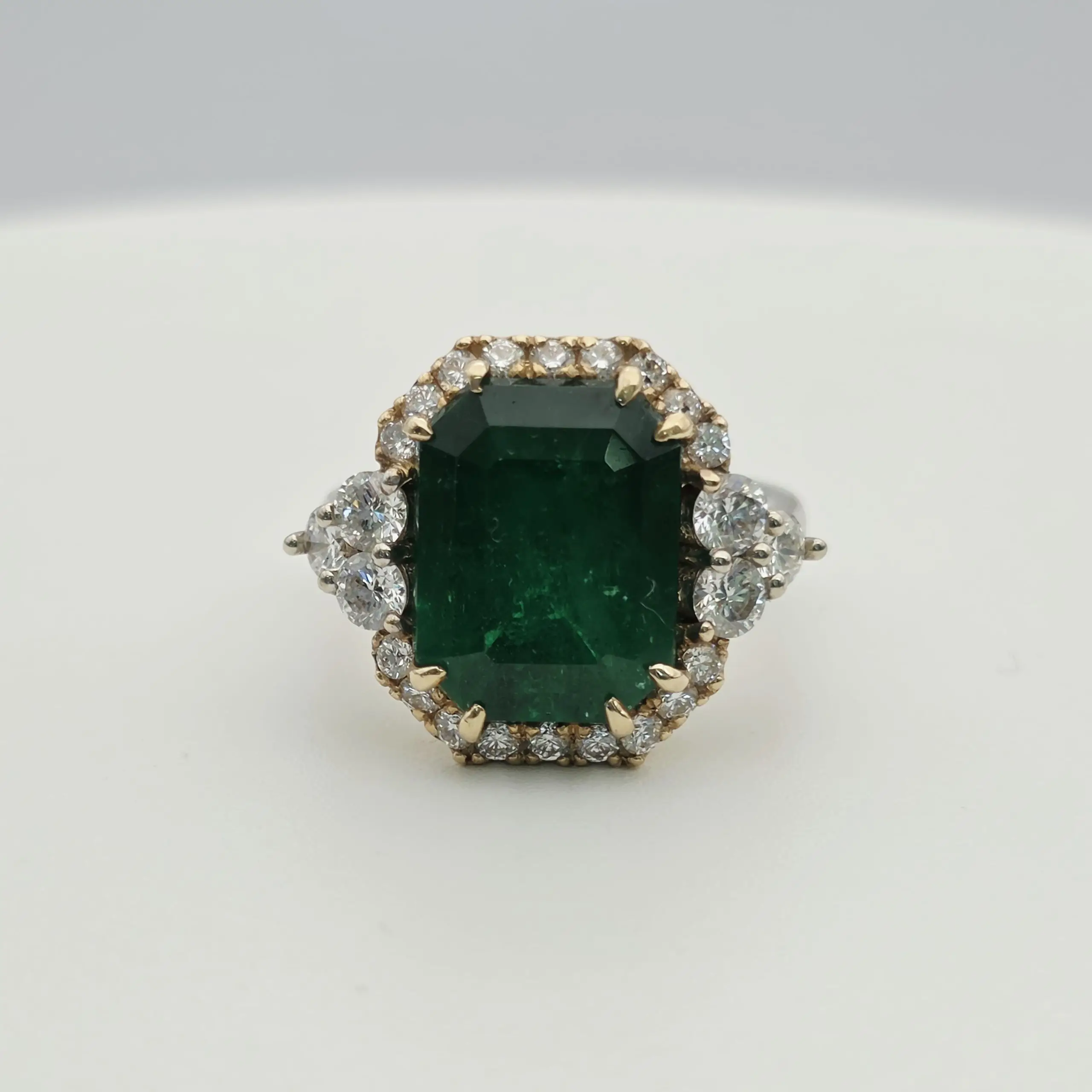 Emerald cut natural emerald and diamond three stone ring in 14K gold