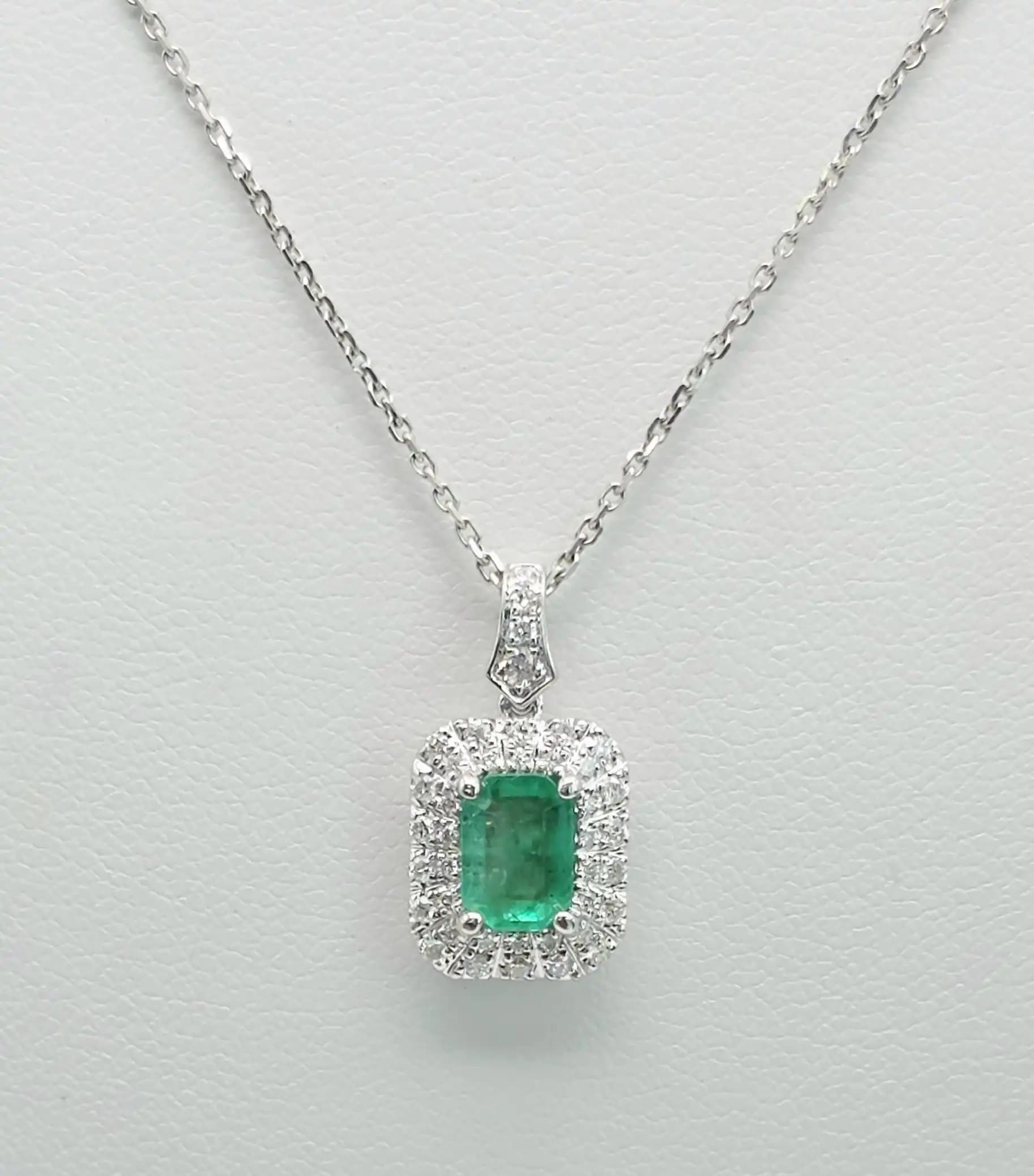 0.84 cts emerald cut natural emerald halo pendant in 18K white gold