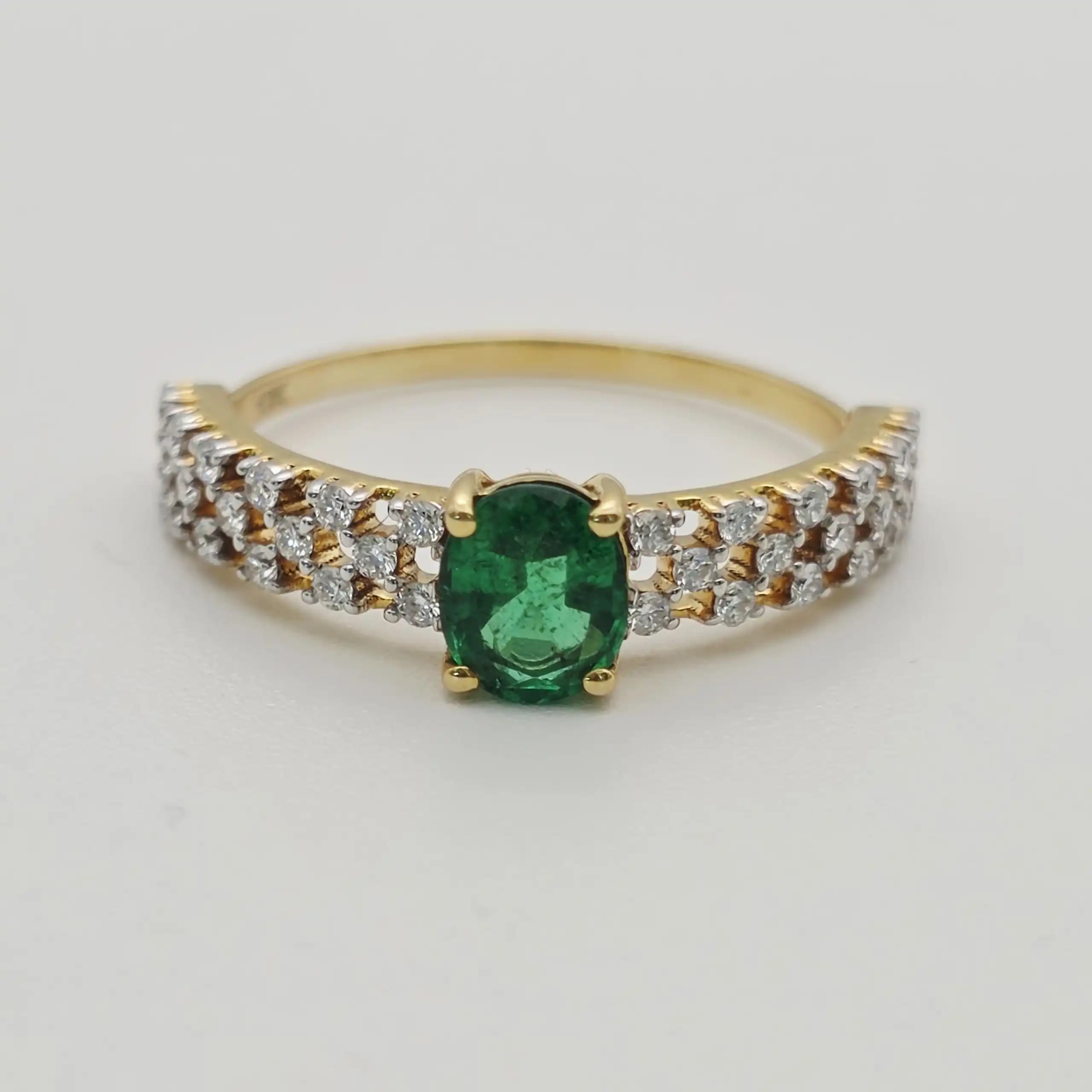 0.53 cts oval natural emerald and diamond ring in 18K yellow gold