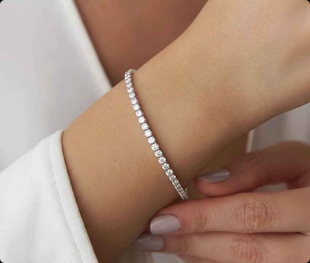 A diamond bracelet being cleaned with a soft cloth
