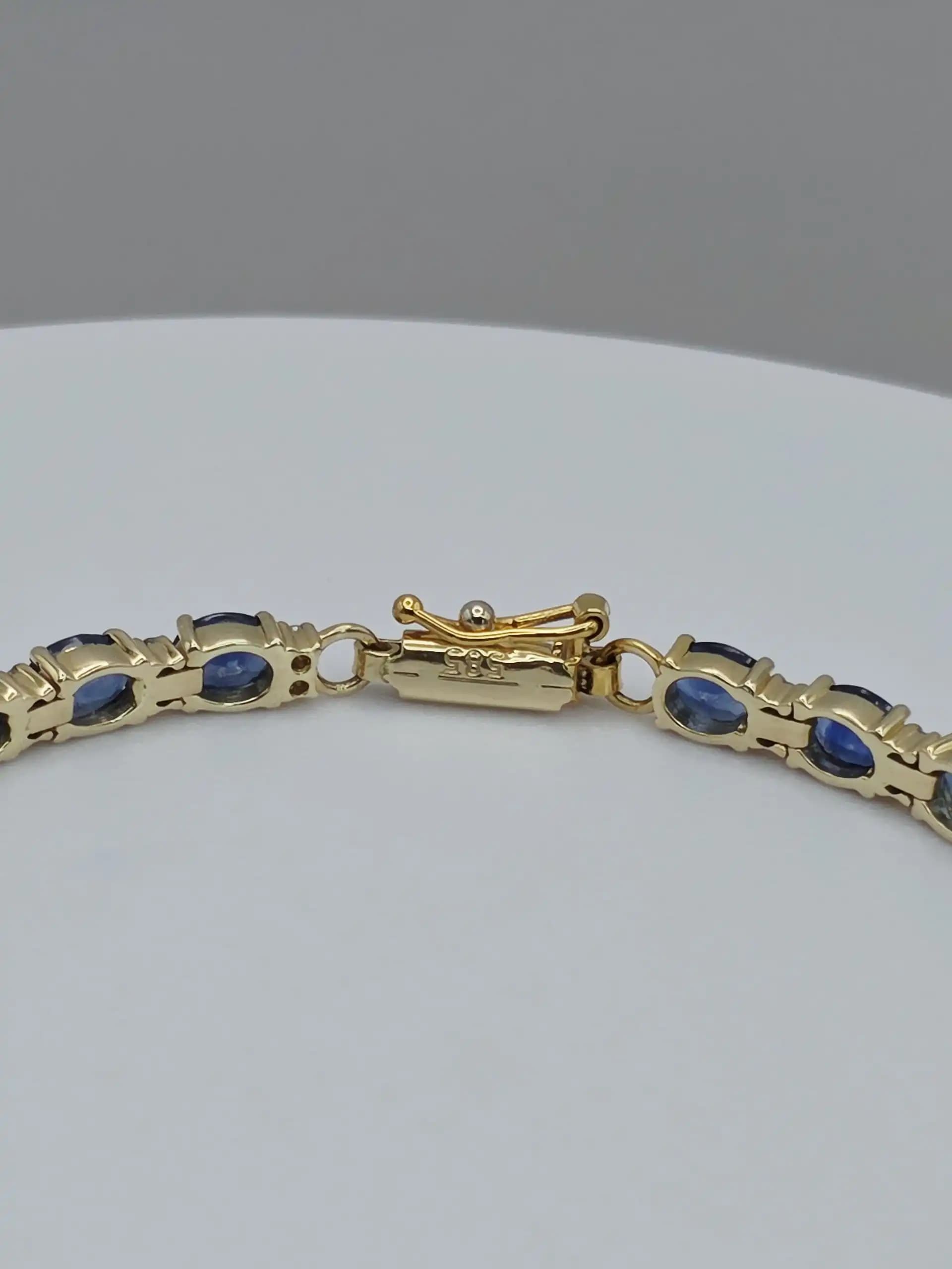 1.97 cts oval natural blue sapphire and diamond tennis bracelet in 14K yellow gold