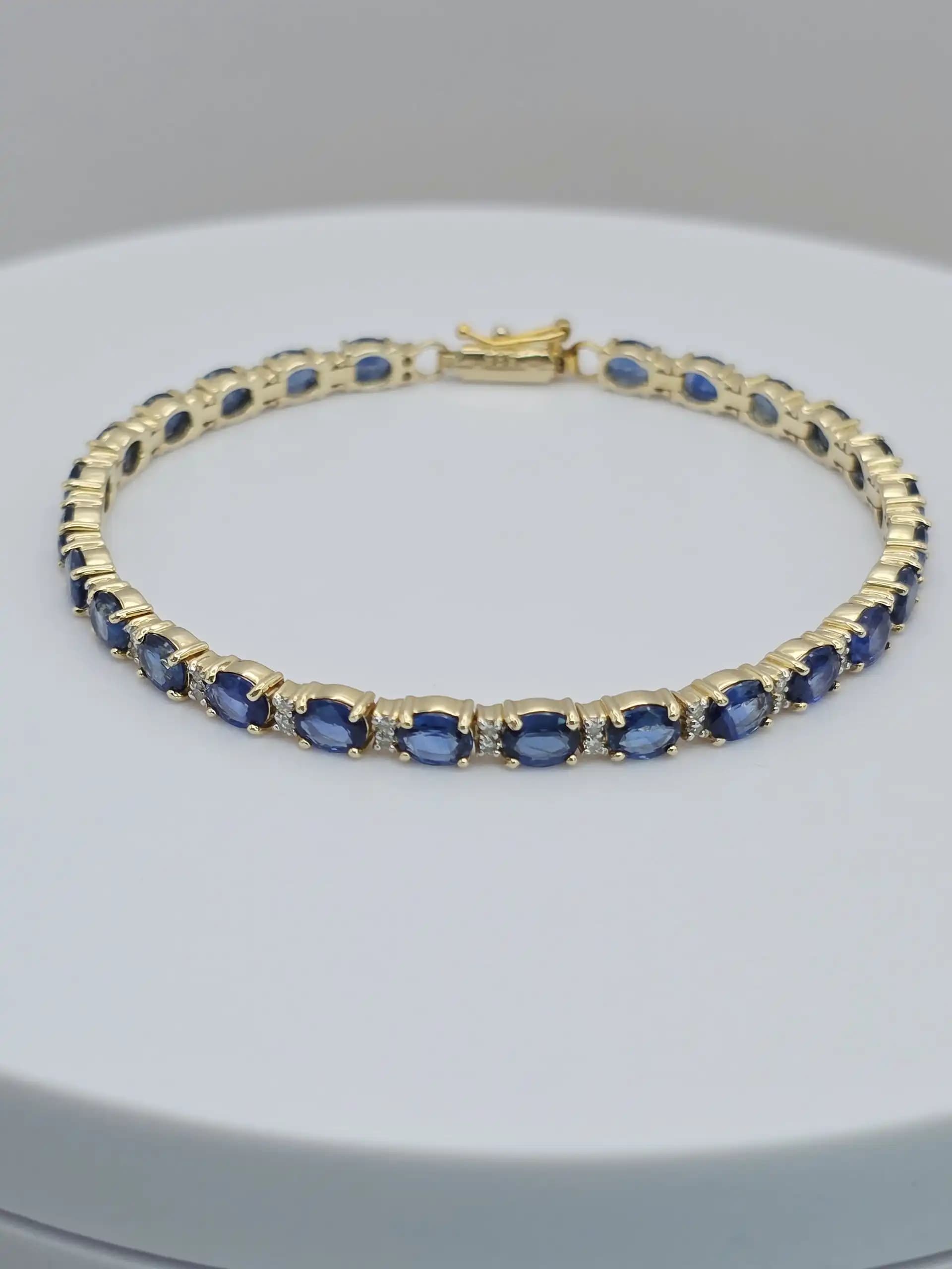 1.97 cts oval natural blue sapphire and diamond tennis bracelet in 14K yellow gold
