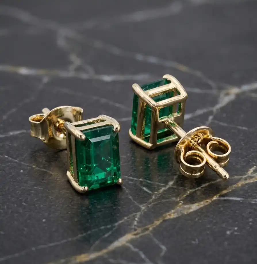 0.50 cts emerald cut natural emerald stud earrings in 14K yellow gold