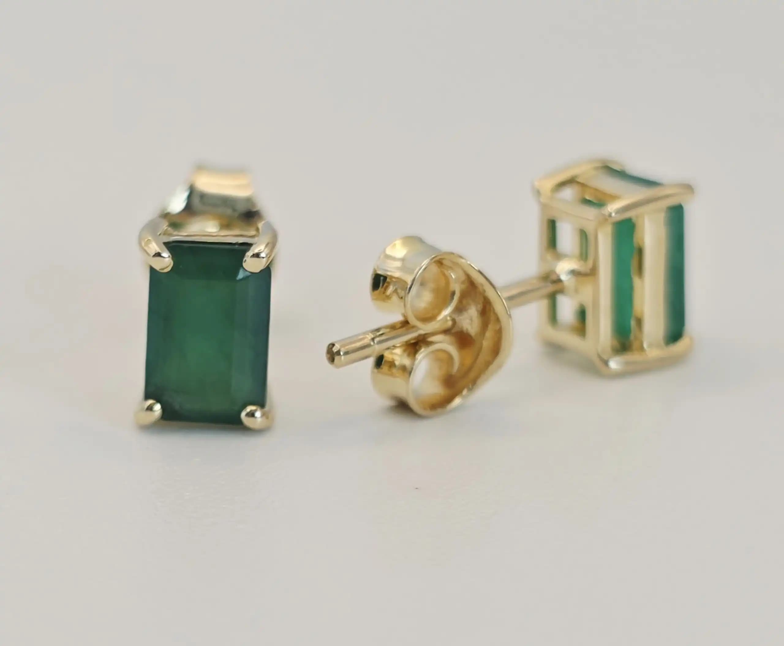 0.50 cts emerald cut natural emerald stud earrings in 14K yellow gold