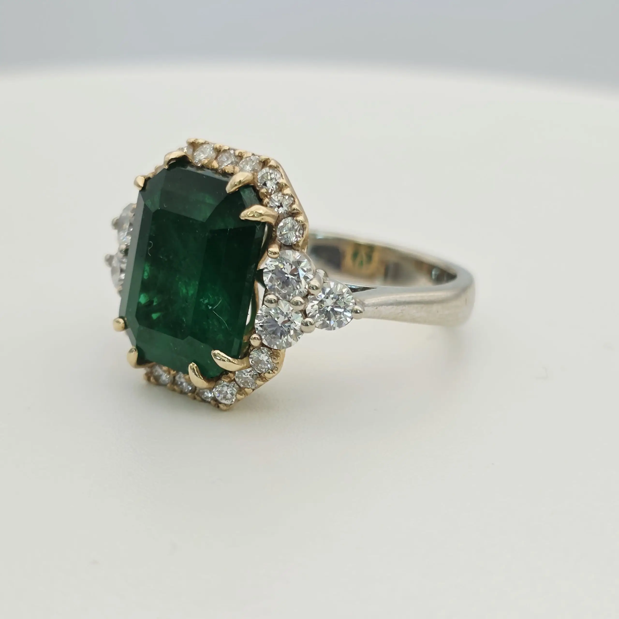 Emerald cut natural emerald and diamond three stone ring in 14K gold