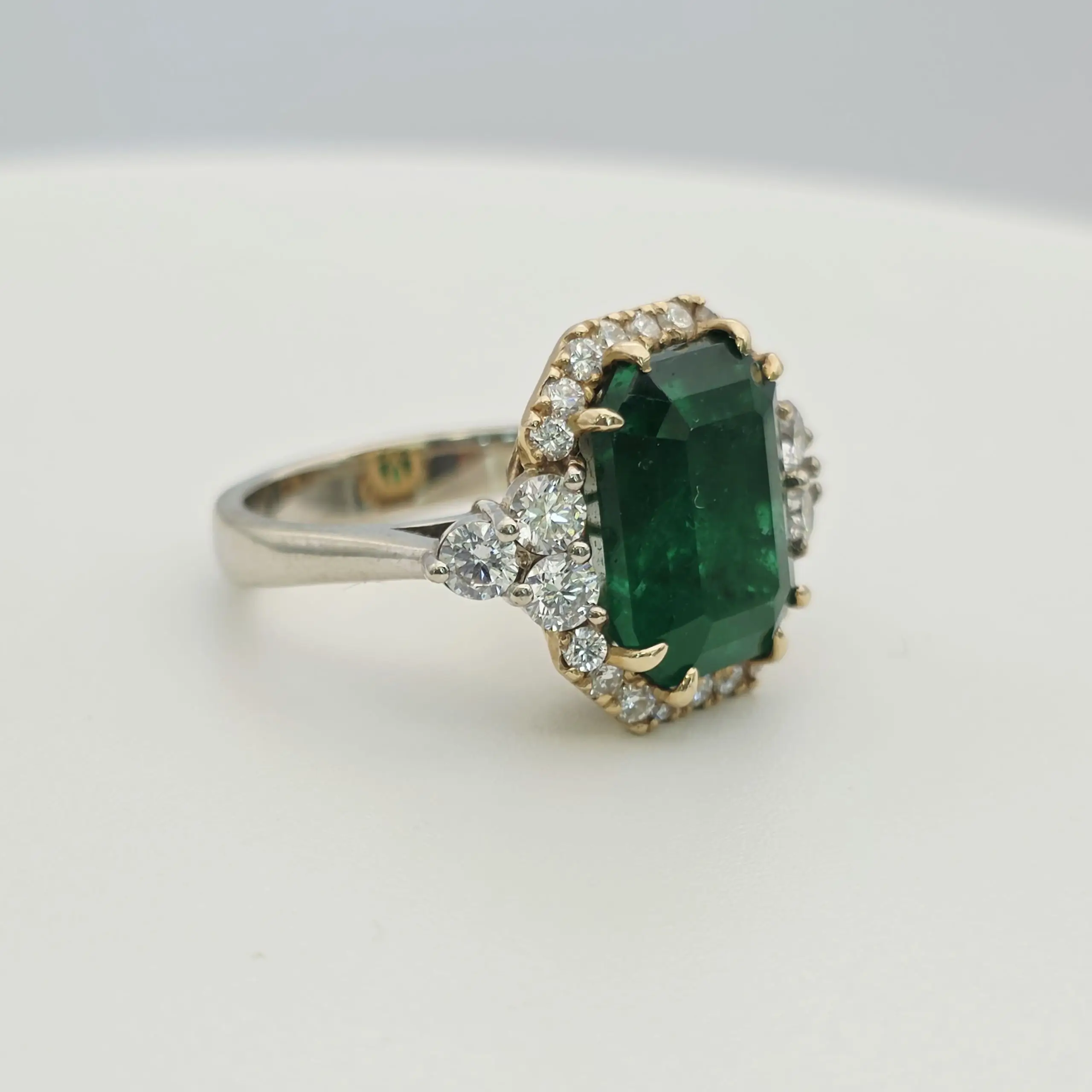 Emerald cut natural emerald and diamond three stone ring in 14K gold