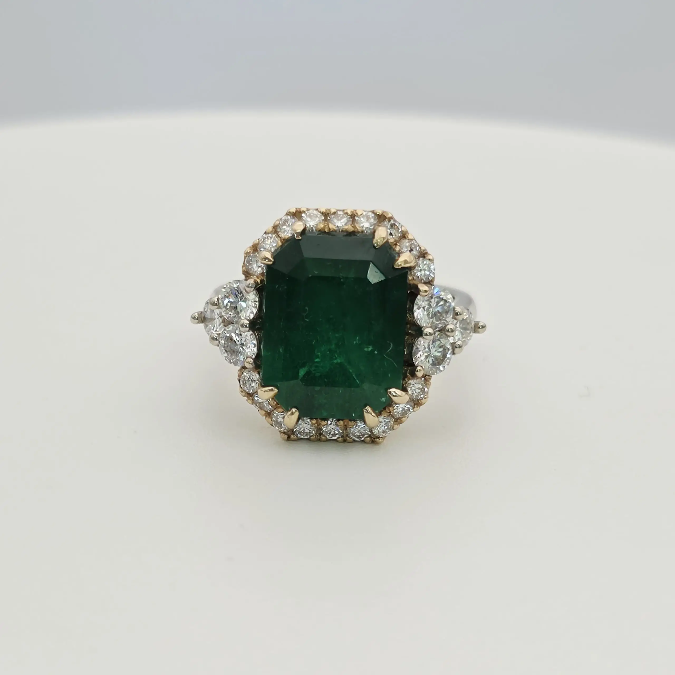 Emerald cut natural emerald and diamond three stone ring in 14K gold