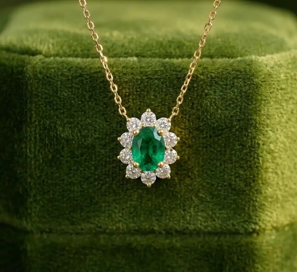 0.40 cts oval natural emerald and diamond halo pendant in 18K yellow gold