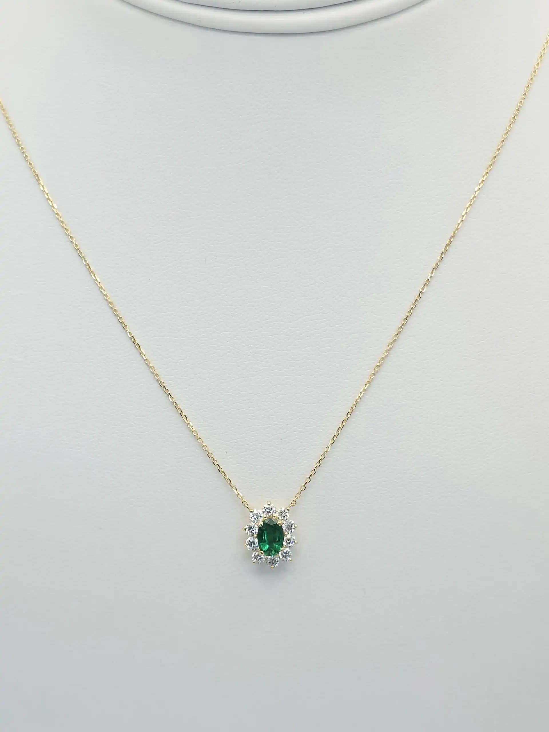 0.40 cts oval natural emerald and diamond halo pendant in 18K yellow gold