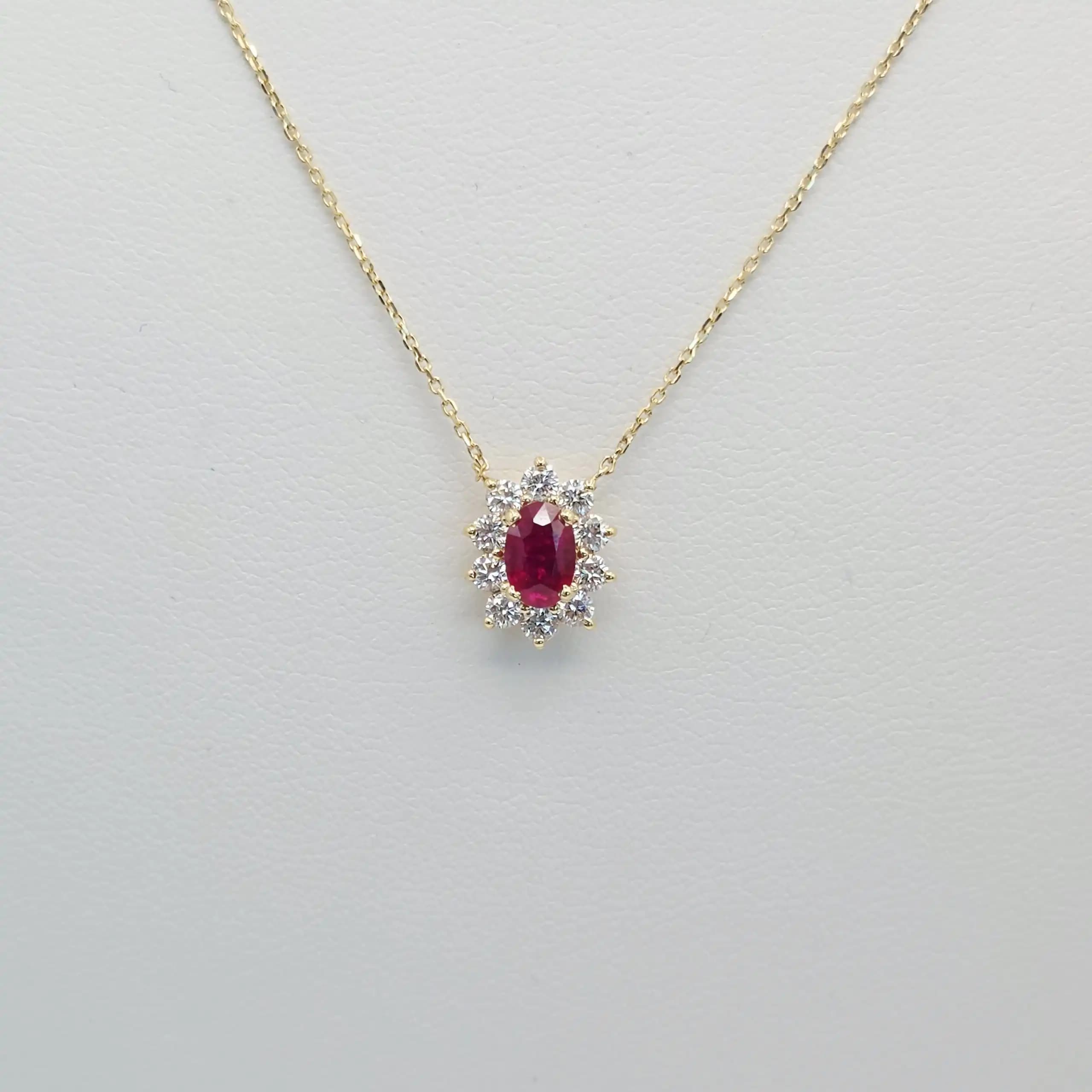 0.60 cts oval natural ruby and diamond halo pendant in 18K yellow gold