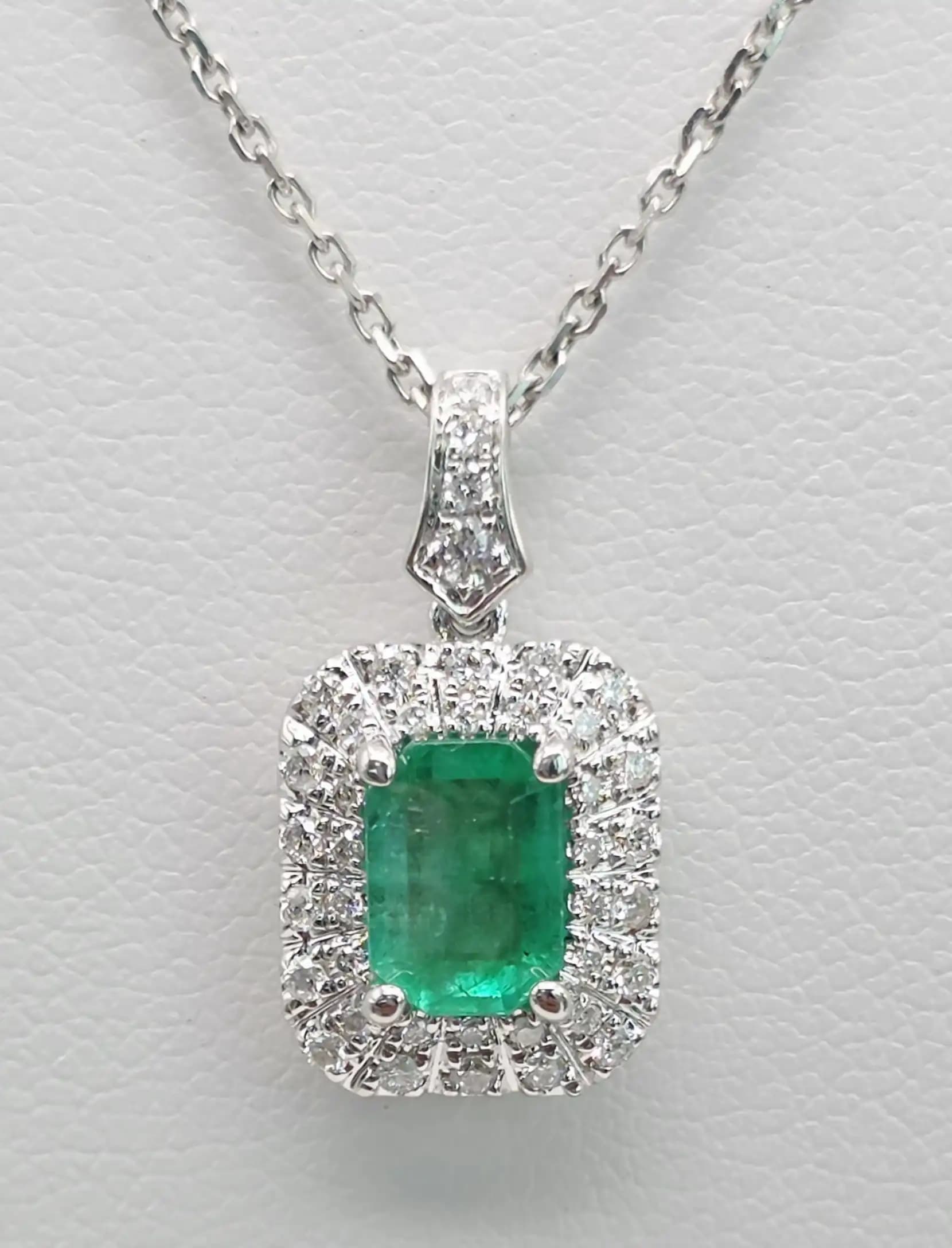 0.84 cts emerald cut natural emerald halo pendant in 18K white gold