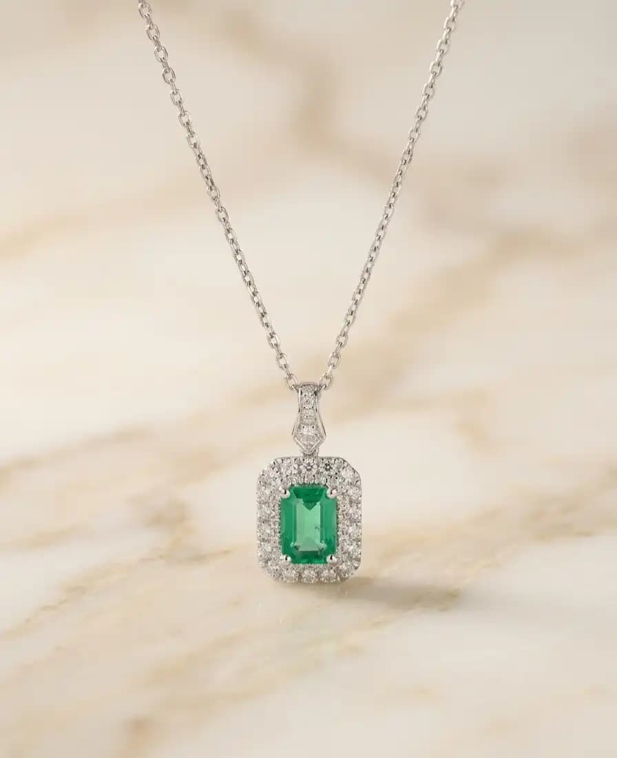 0.84 cts emerald cut natural emerald halo pendant in 18K white gold