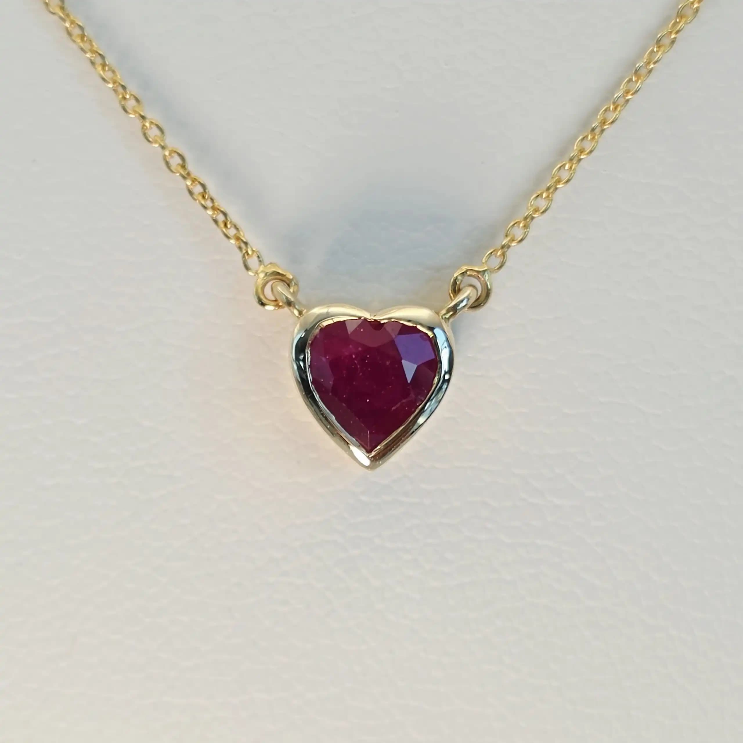 0.60 to 0.75 cts heart shape natural ruby bezel necklace in 14K yellow gold