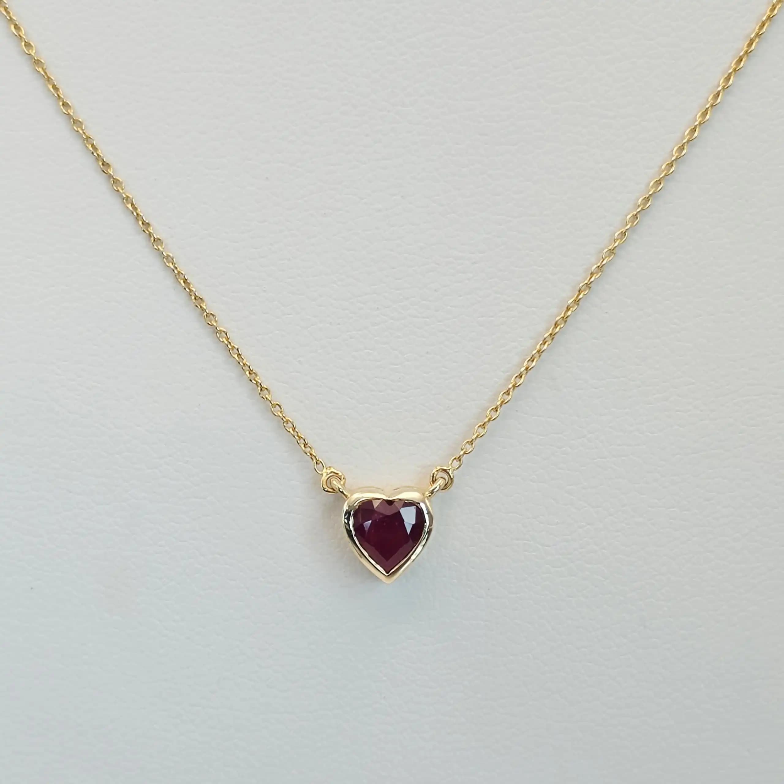 0.60 to 0.75 cts heart shape natural ruby bezel necklace in 14K yellow gold