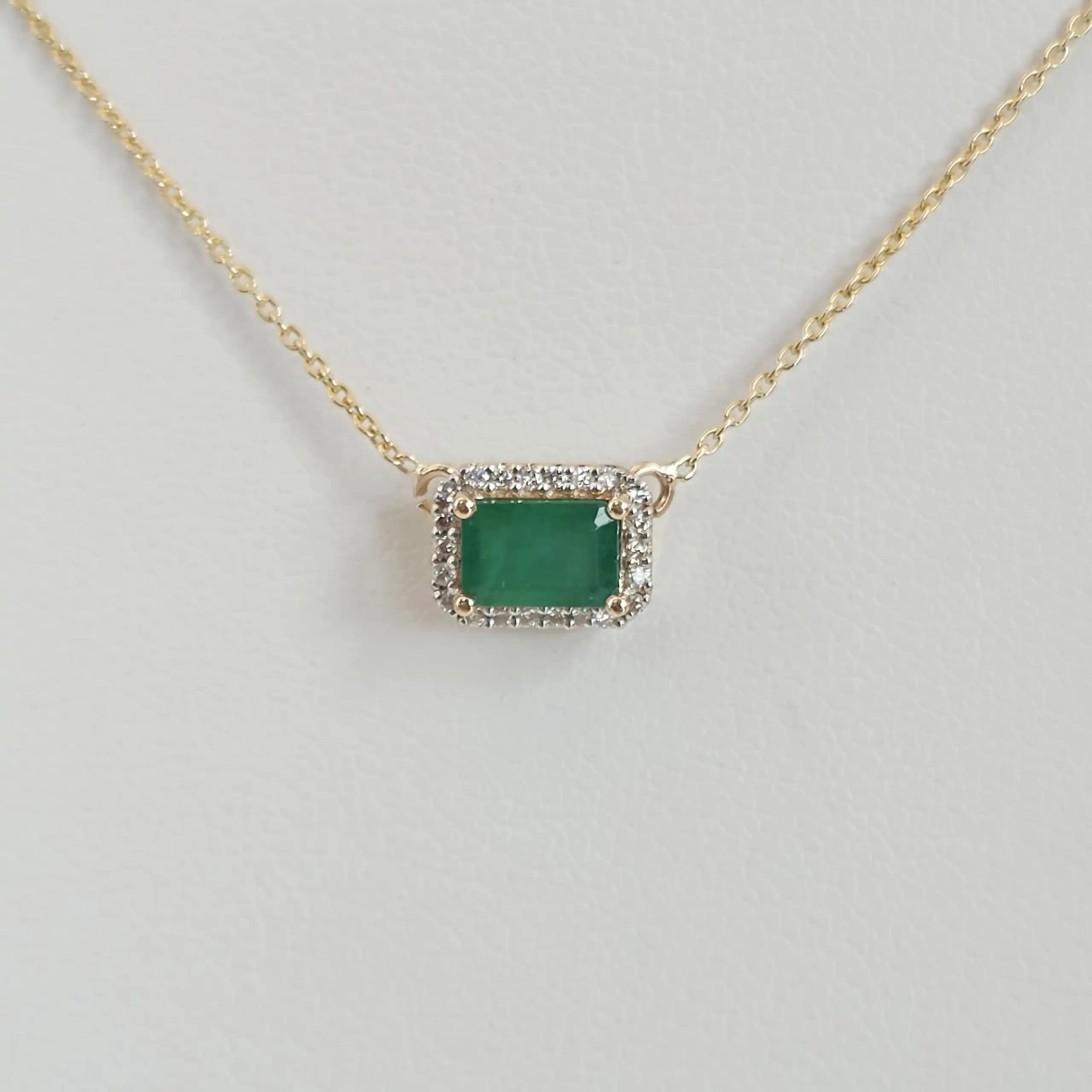 0.60 cts emerald cut natural emerald halo necklace in 14K yellow gold