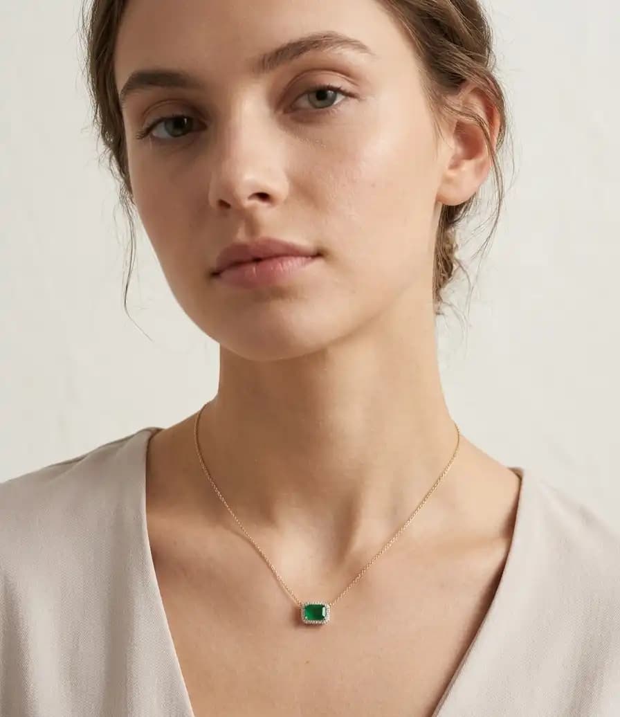 0.60 cts emerald cut natural emerald halo necklace in 14K yellow gold