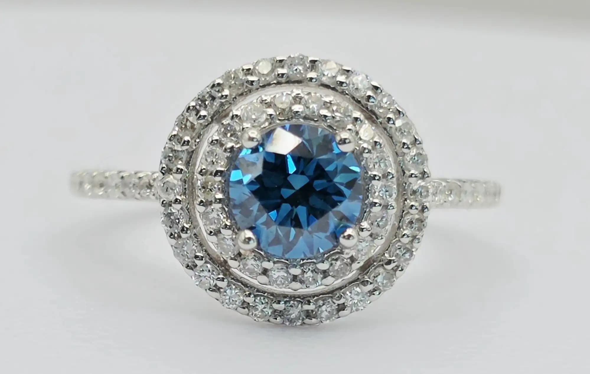 1.25 cts natural blue gemstone and diamond halo ring in 14K white gold
