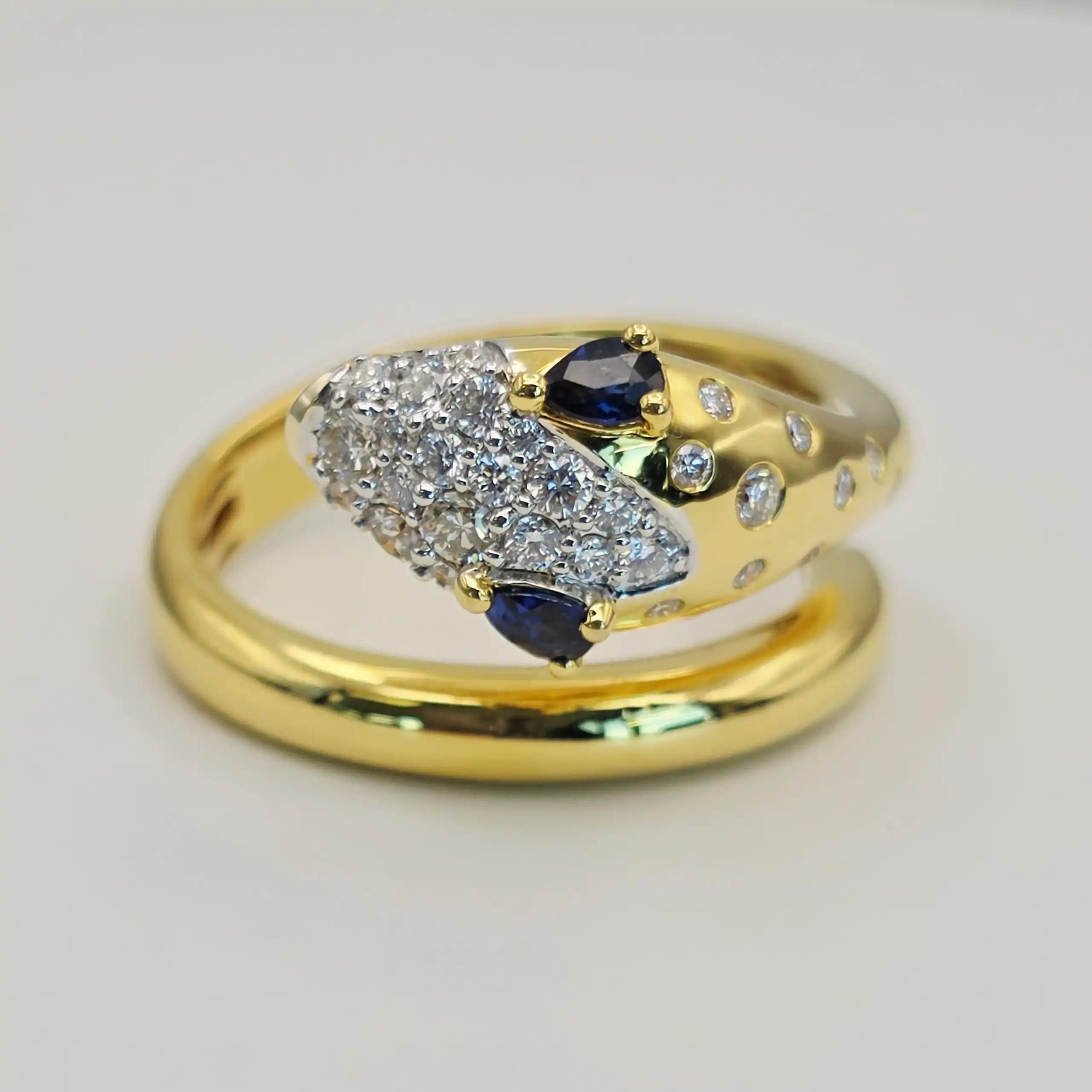 0.21 cts natural blue sapphire and diamond pavé bypass ring in 18K yellow gold