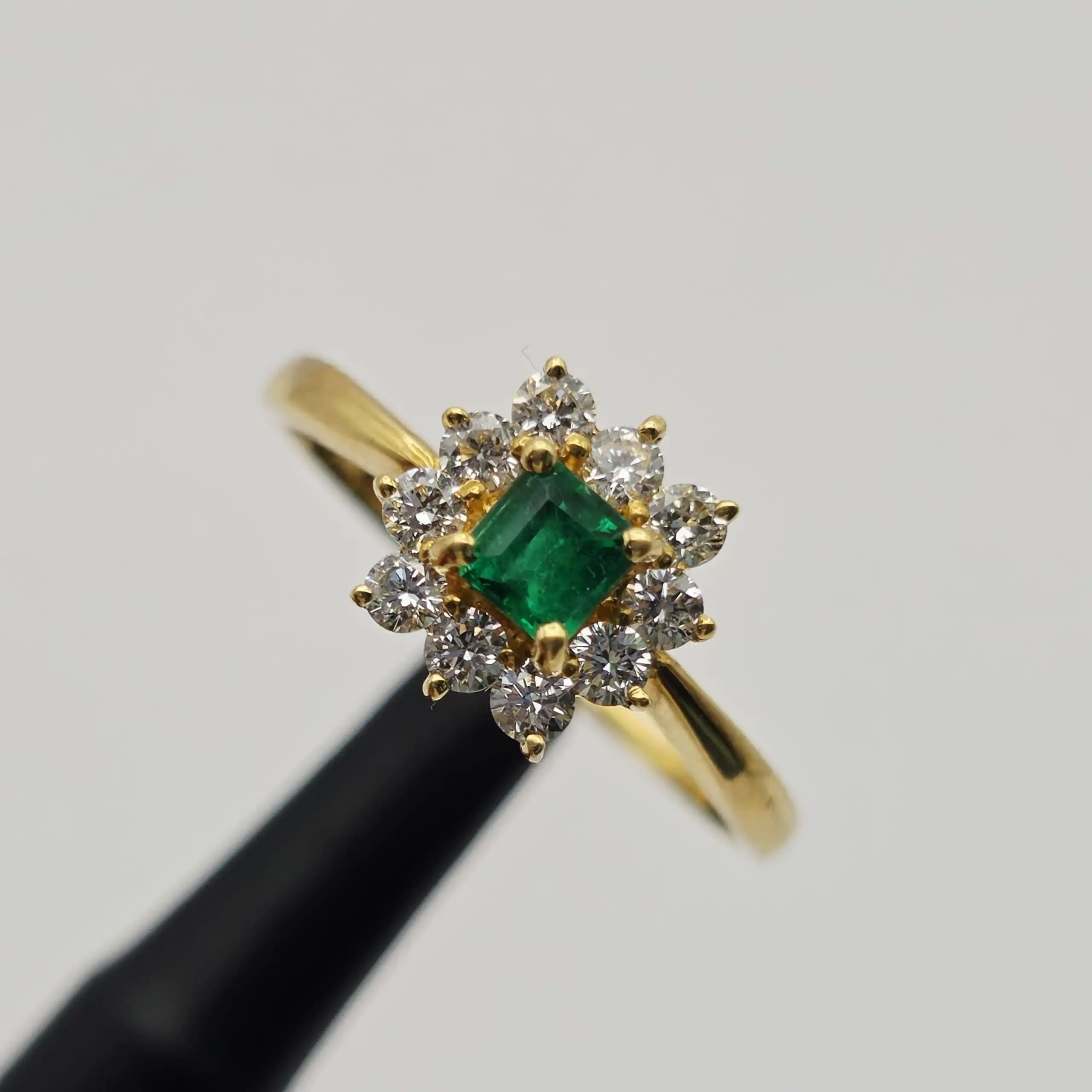 0.35 cts emerald cut natural emerald and diamond cluster ring in 18K yellow gold