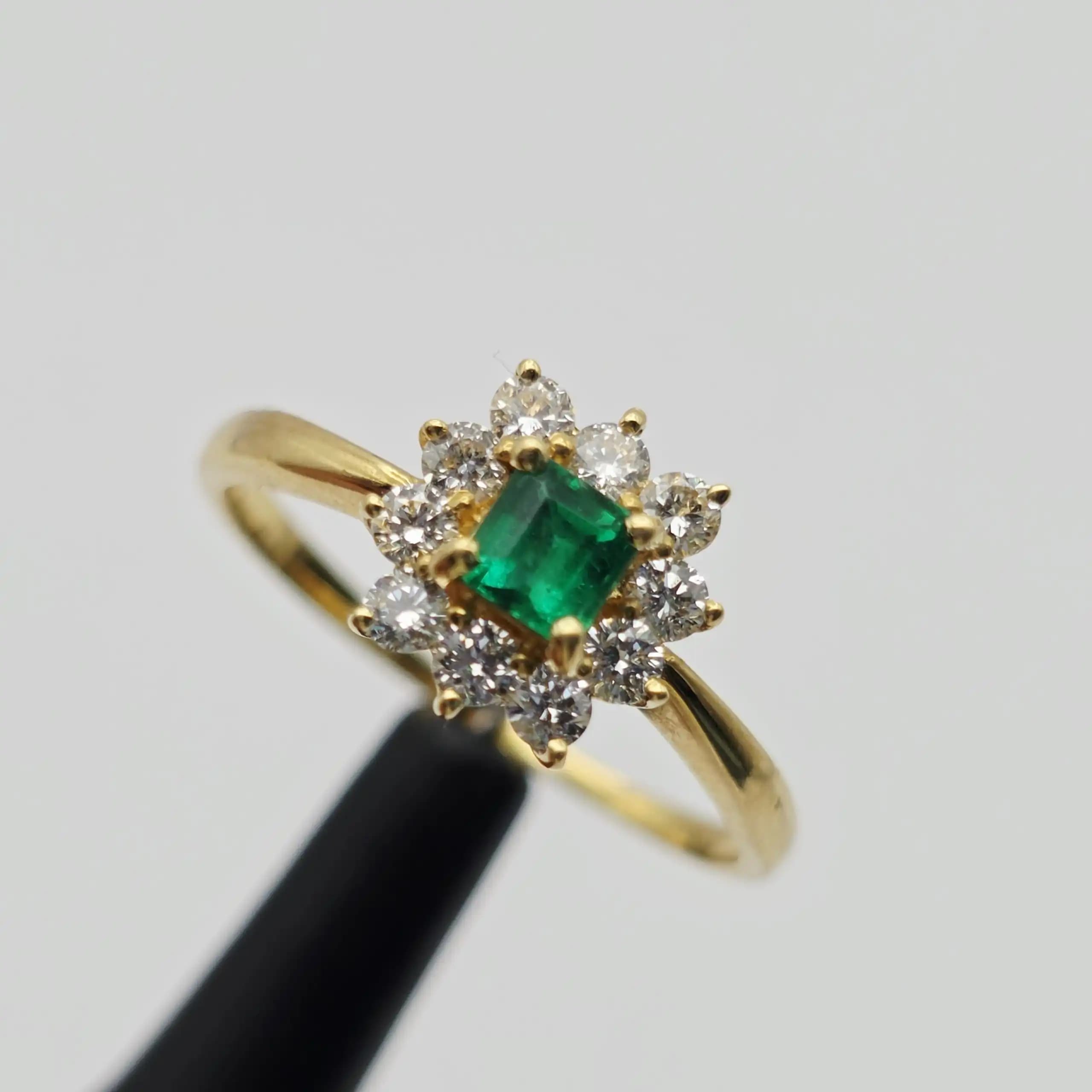 0.35 cts emerald cut natural emerald and diamond cluster ring in 18K yellow gold