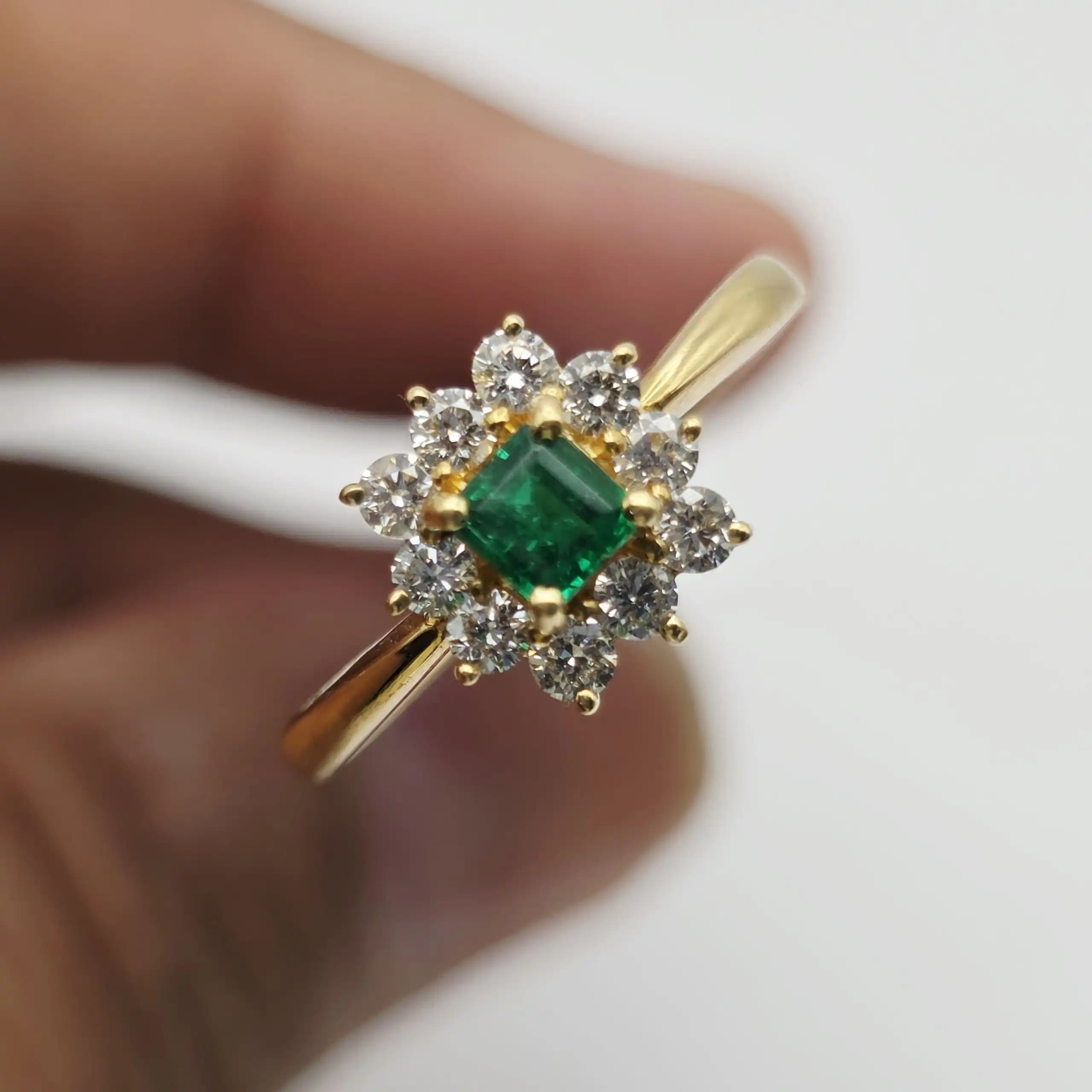0.35 cts emerald cut natural emerald and diamond cluster ring in 18K yellow gold