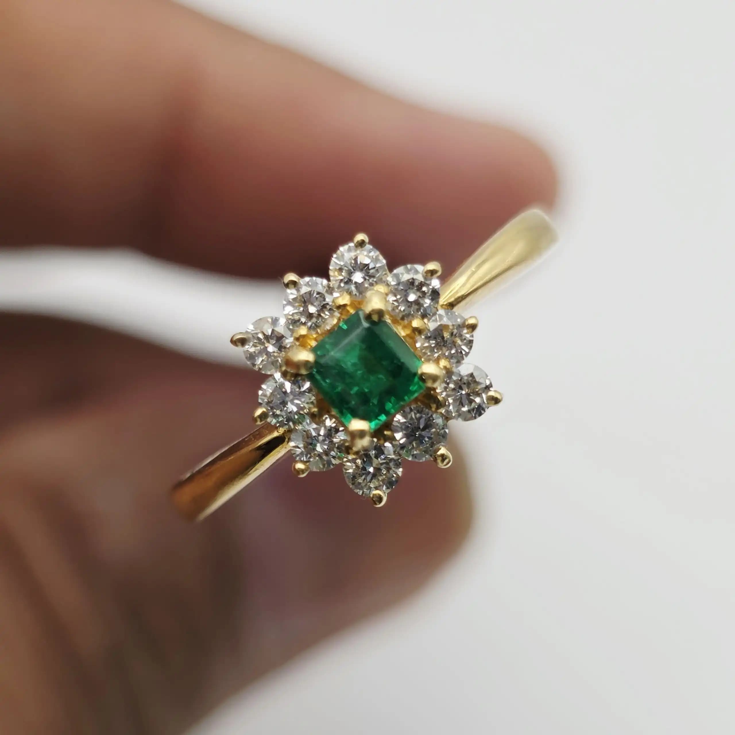 0.35 cts emerald cut natural emerald and diamond cluster ring in 18K yellow gold