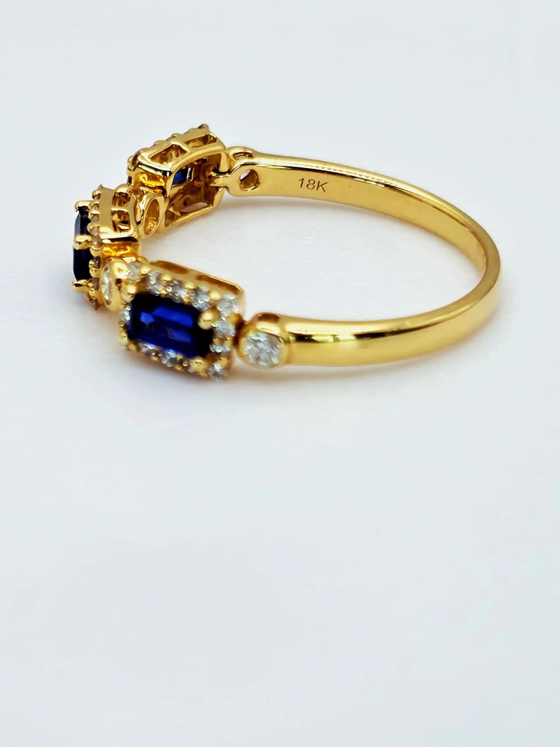 0.45 cts emerald cut natural emerald and diamond three stone ring in 18K yellow gold