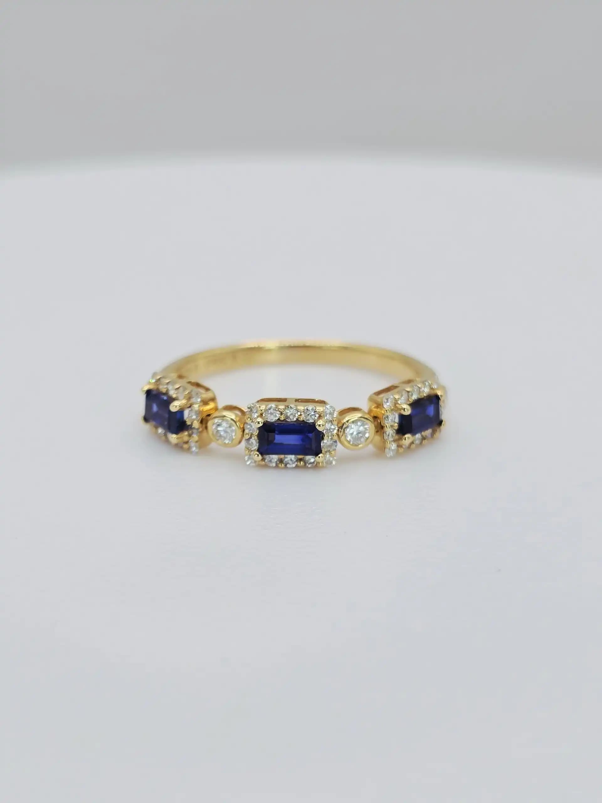 0.55 cts emerald cut natural blue sapphire and diamond band ring in 18K yellow gold