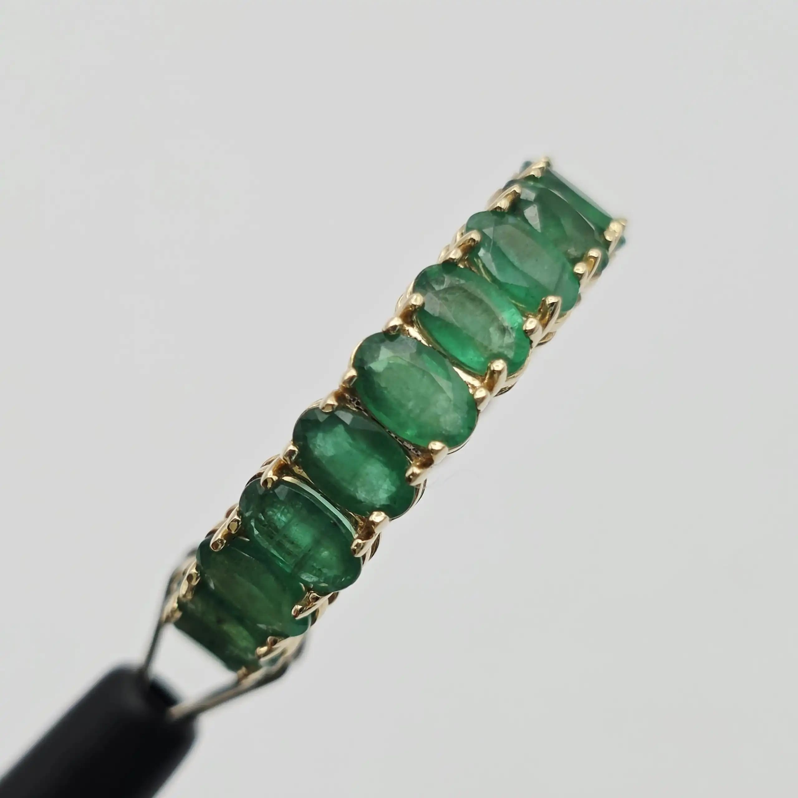 6.24 cts oval natural emerald full eternity ring in 14K yellow gold