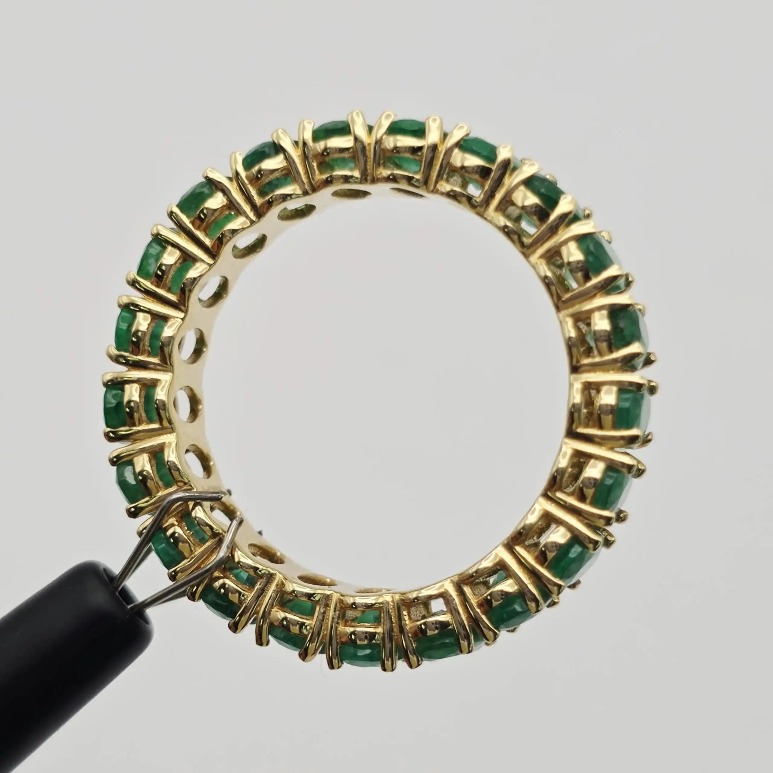 6.24 cts oval natural emerald full eternity ring in 14K yellow gold