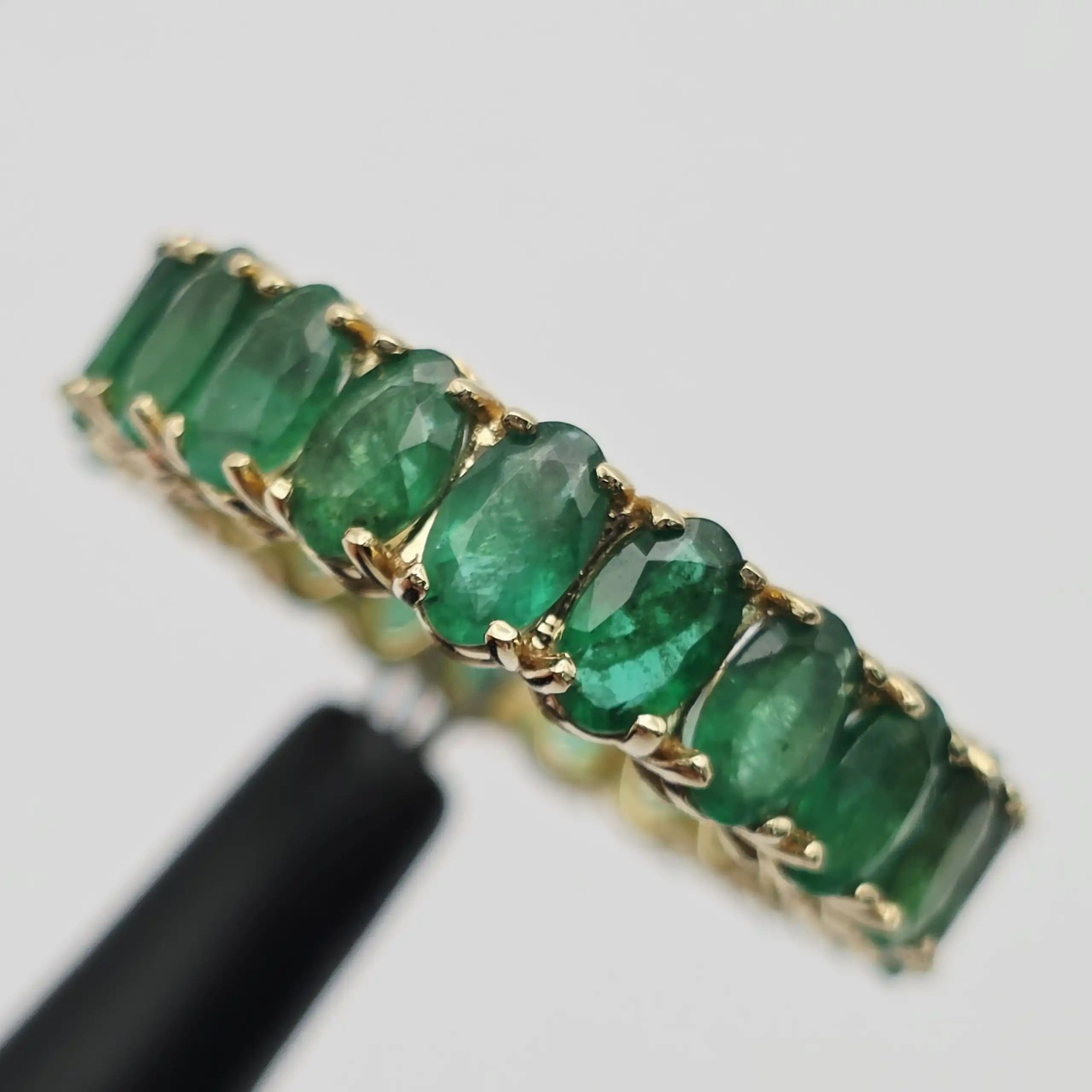 6.24 cts oval natural emerald full eternity ring in 14K yellow gold