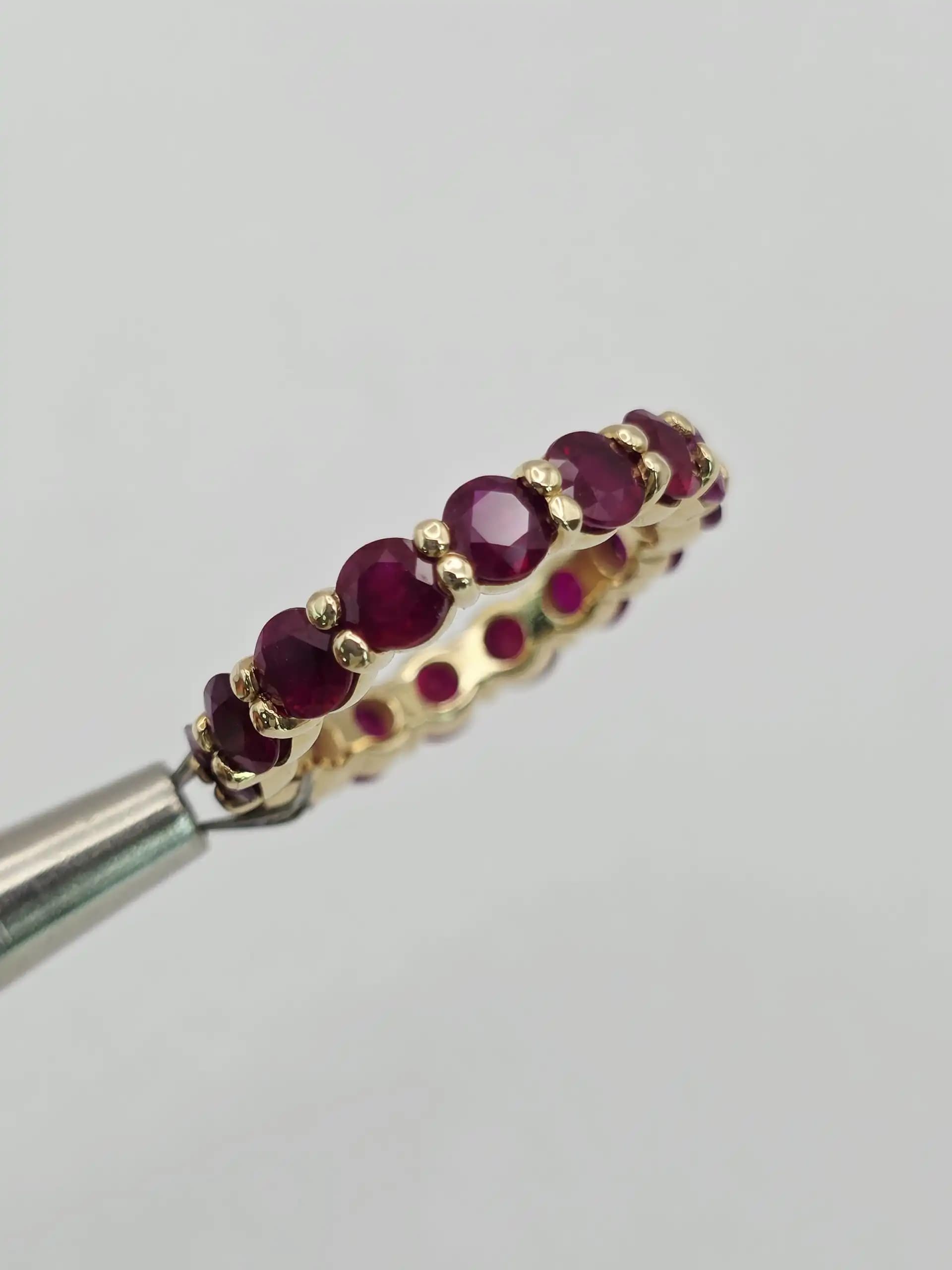 5.10 cts emerald cut natural ruby and diamond eternity ring in 14K white gold