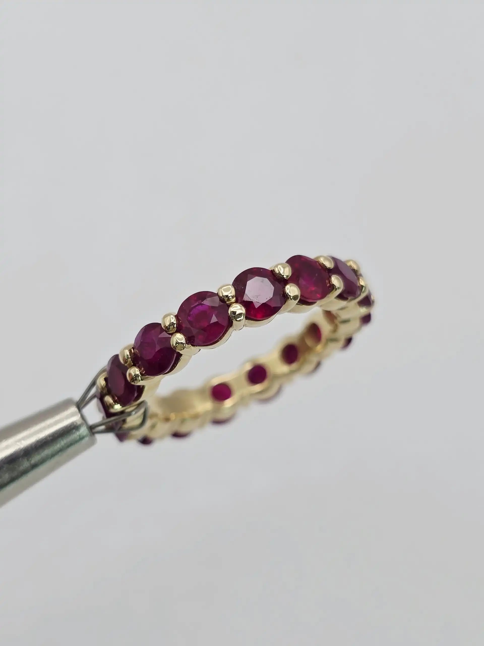 5.10 cts emerald cut natural ruby and diamond eternity ring in 14K white gold