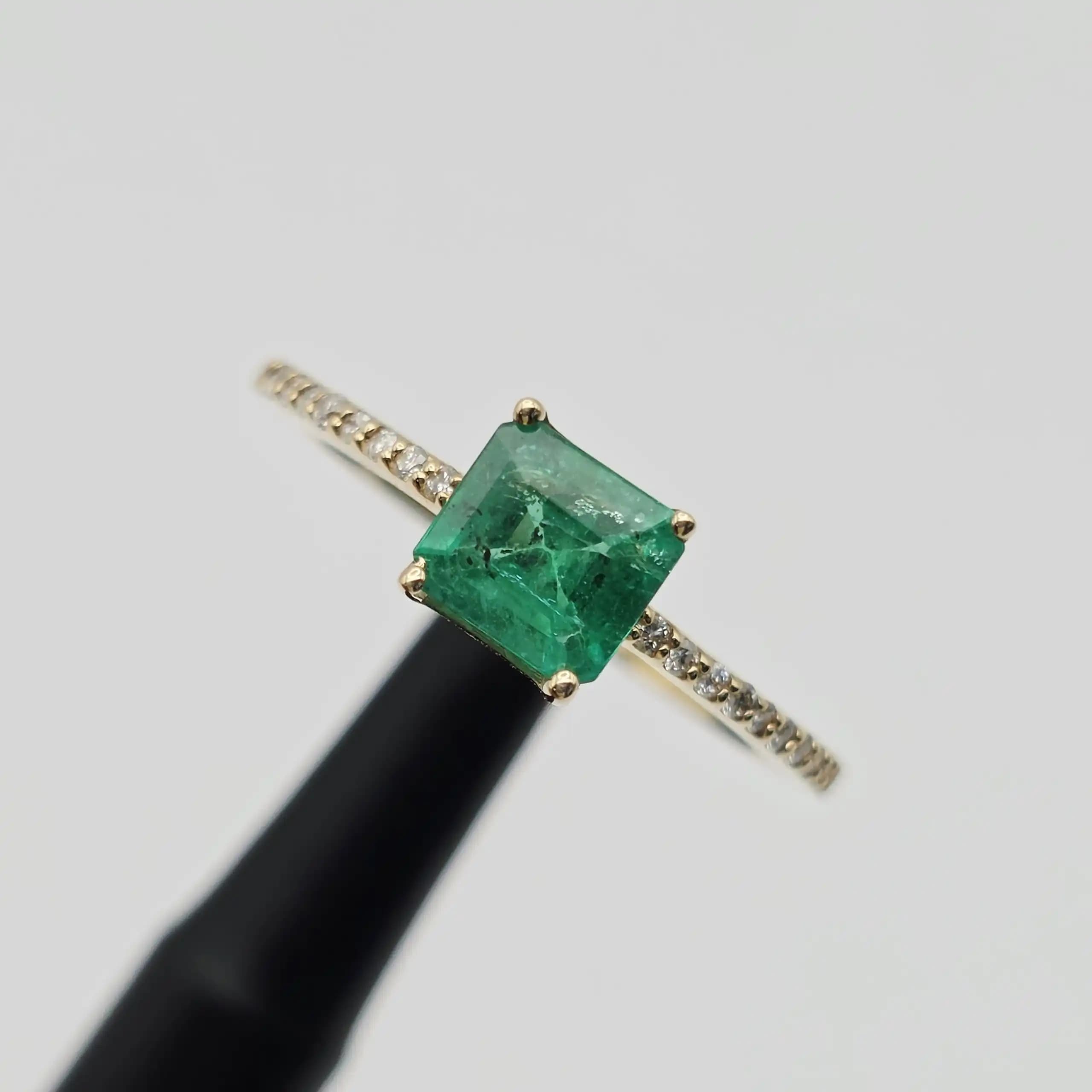 0.61 cts emerald cut natural emerald east west ring in 14K yellow gold