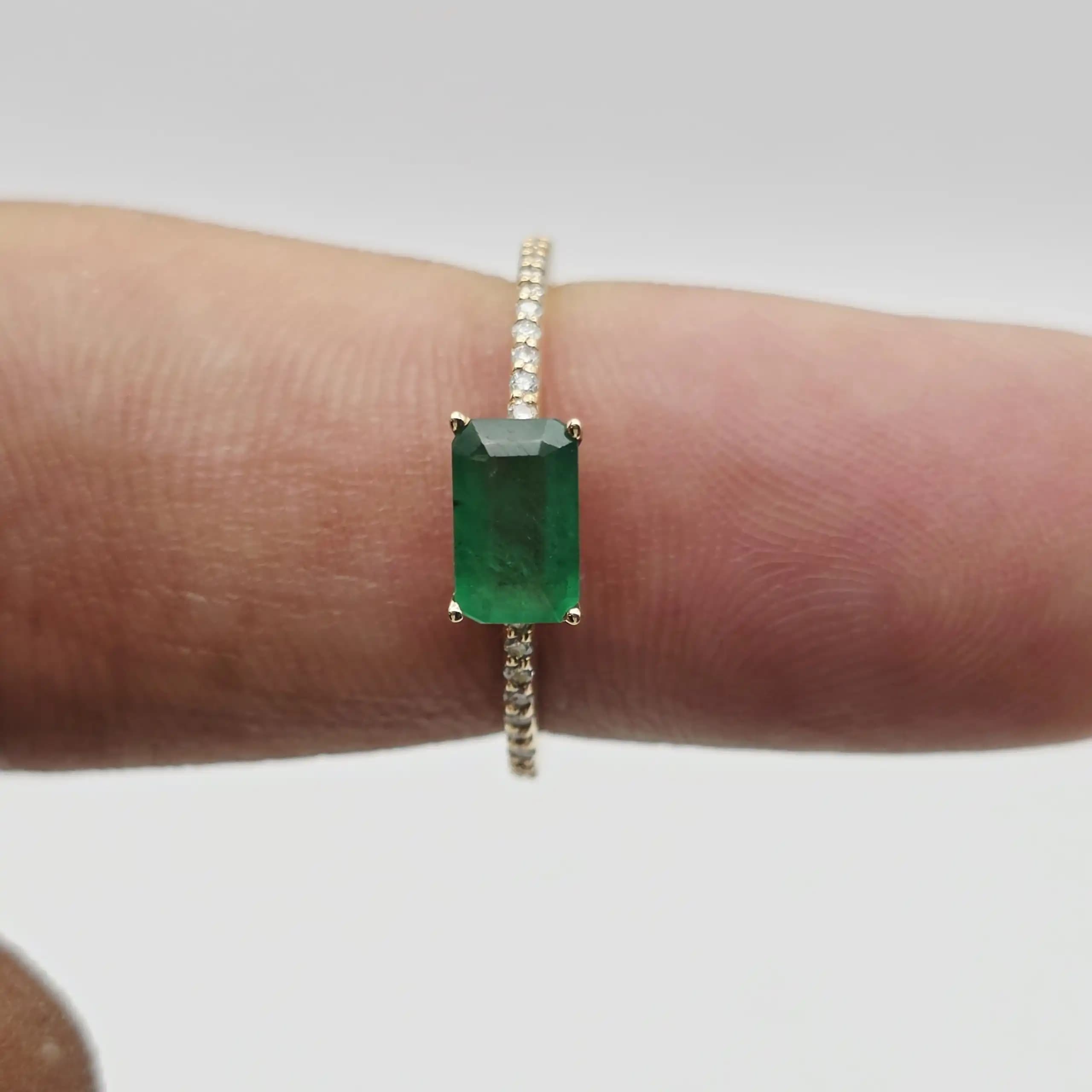 0.61 cts emerald cut natural emerald east west ring in 14K yellow gold