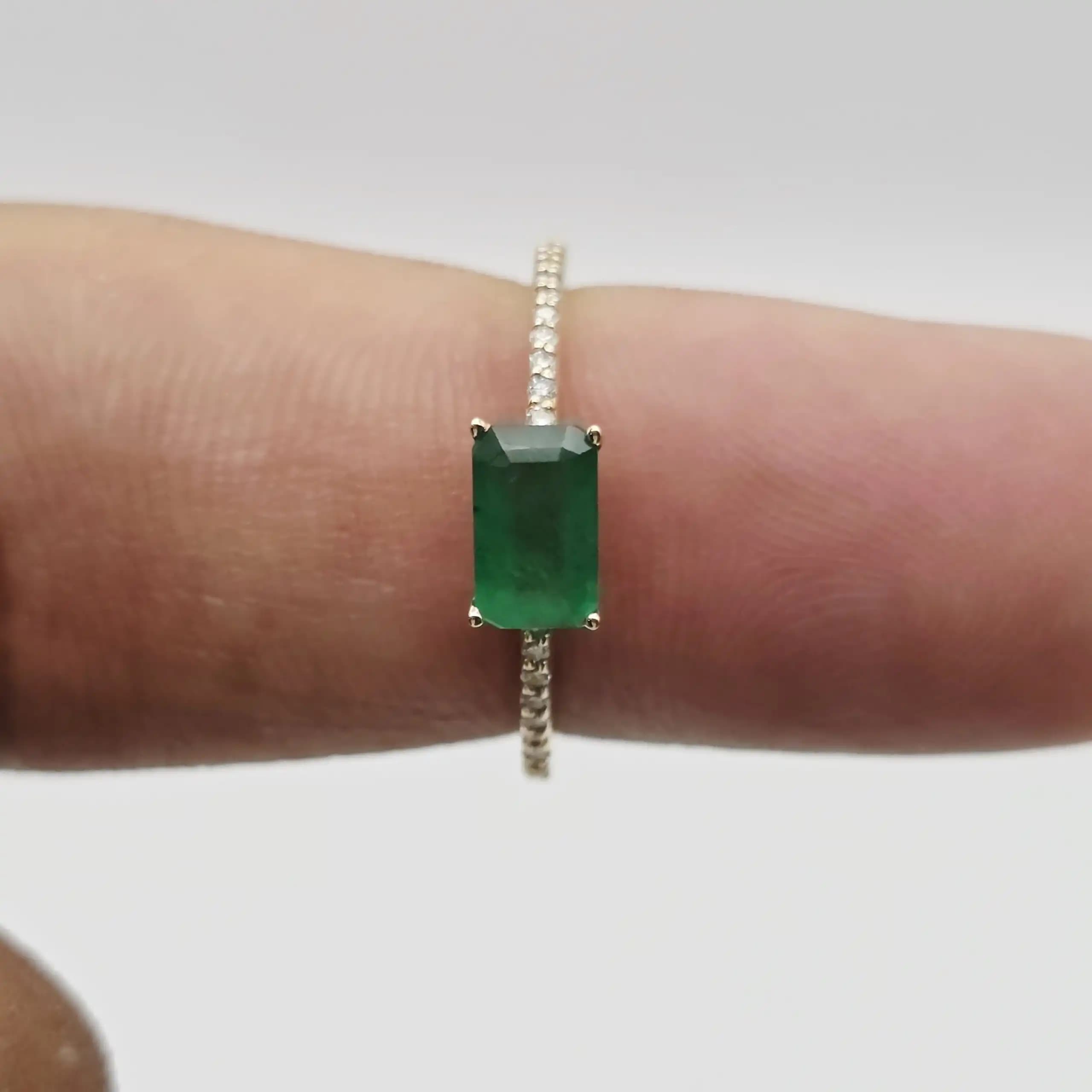 0.61 cts emerald cut natural emerald east west ring in 14K yellow gold