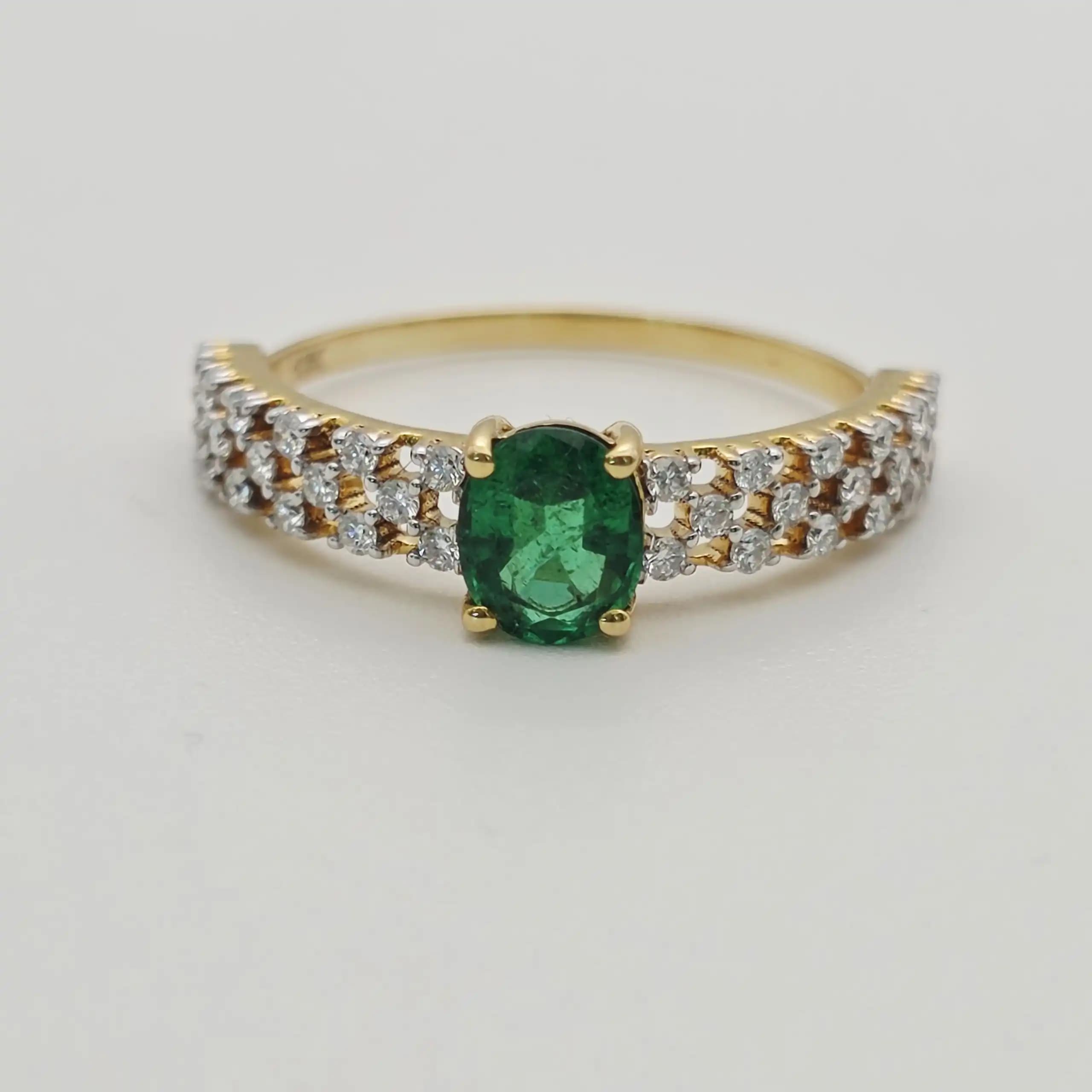 0.53 cts oval natural emerald and diamond ring in 18K yellow gold