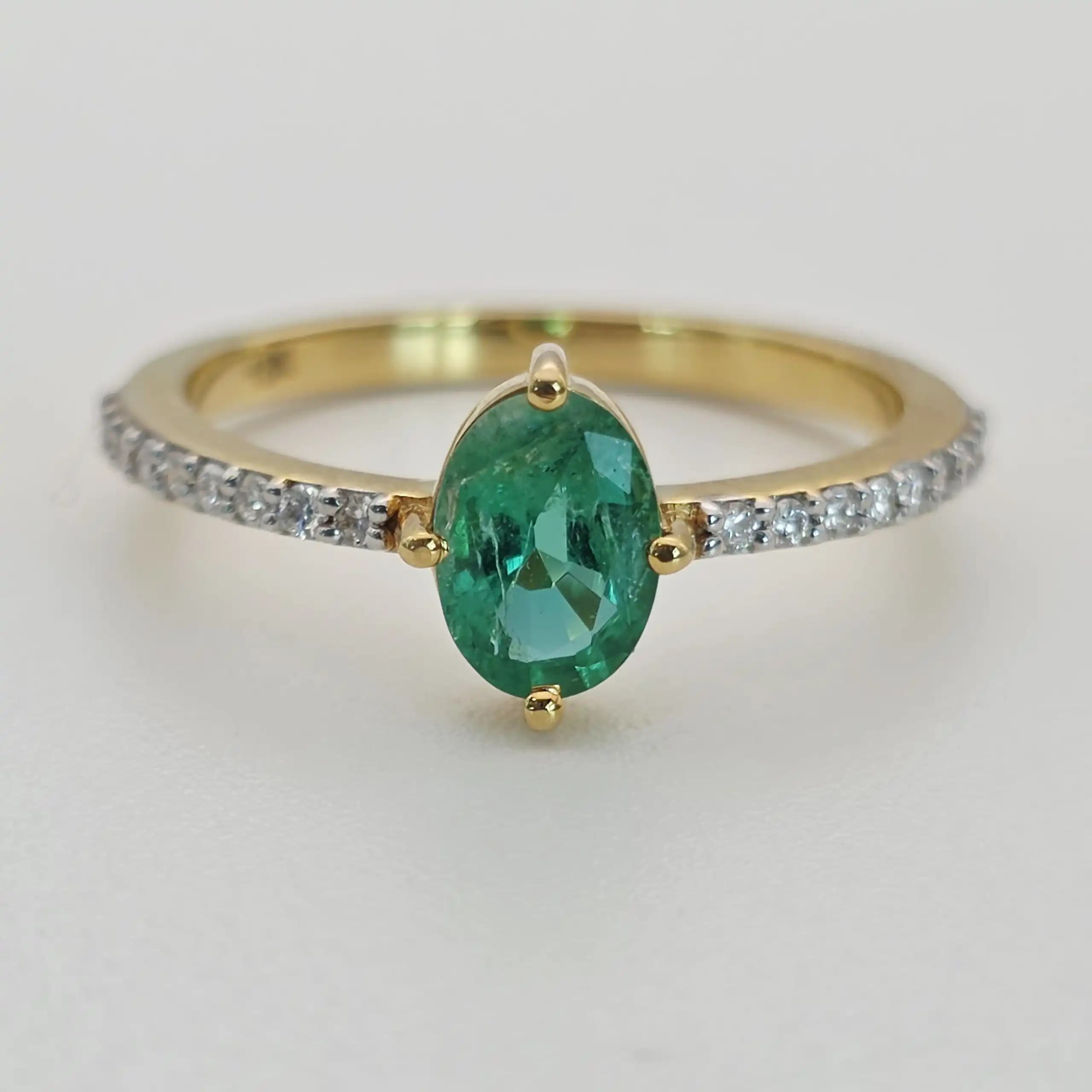 0.64 cts oval natural emerald solitaire ring in 18K yellow gold