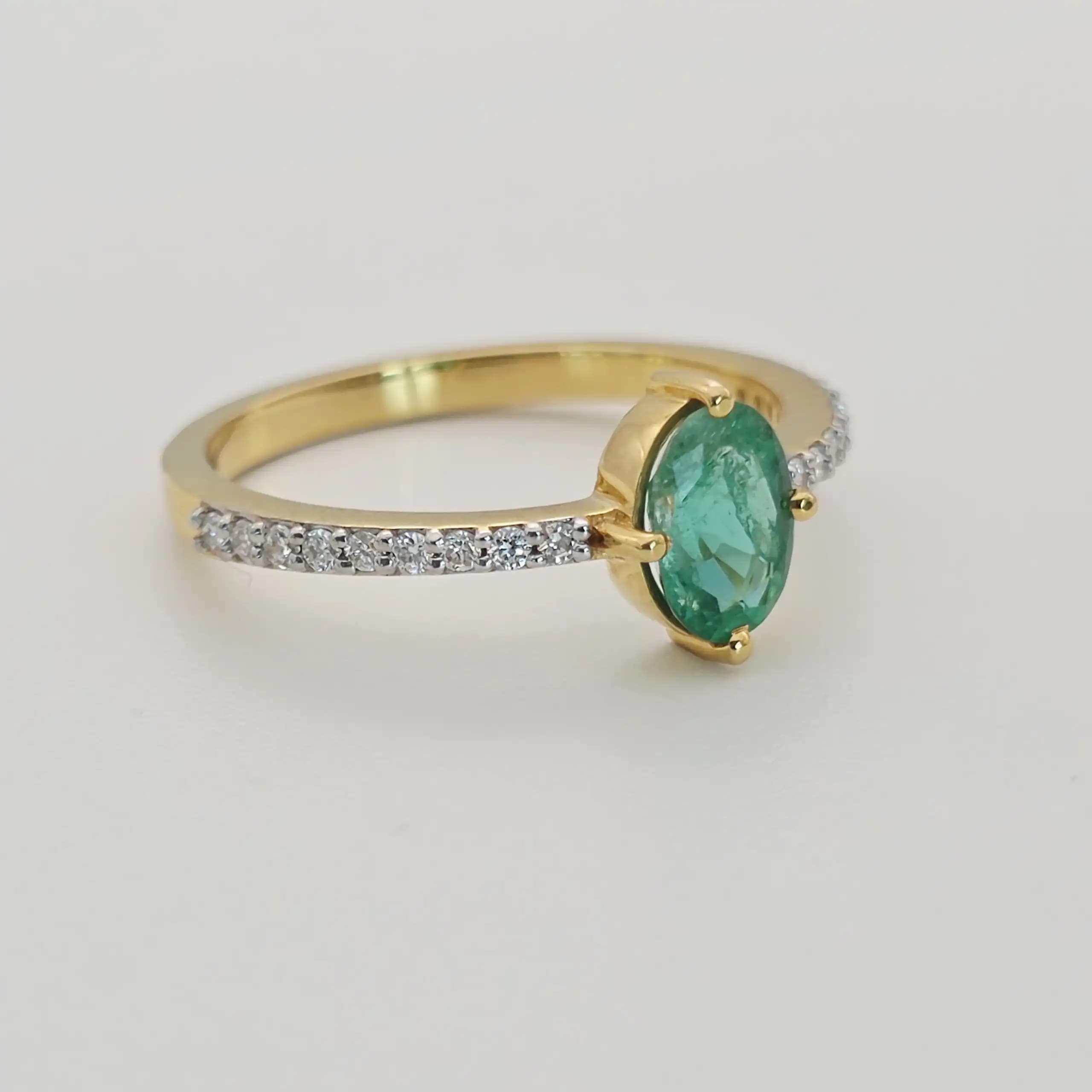 0.64 cts oval natural emerald solitaire ring in 18K yellow gold
