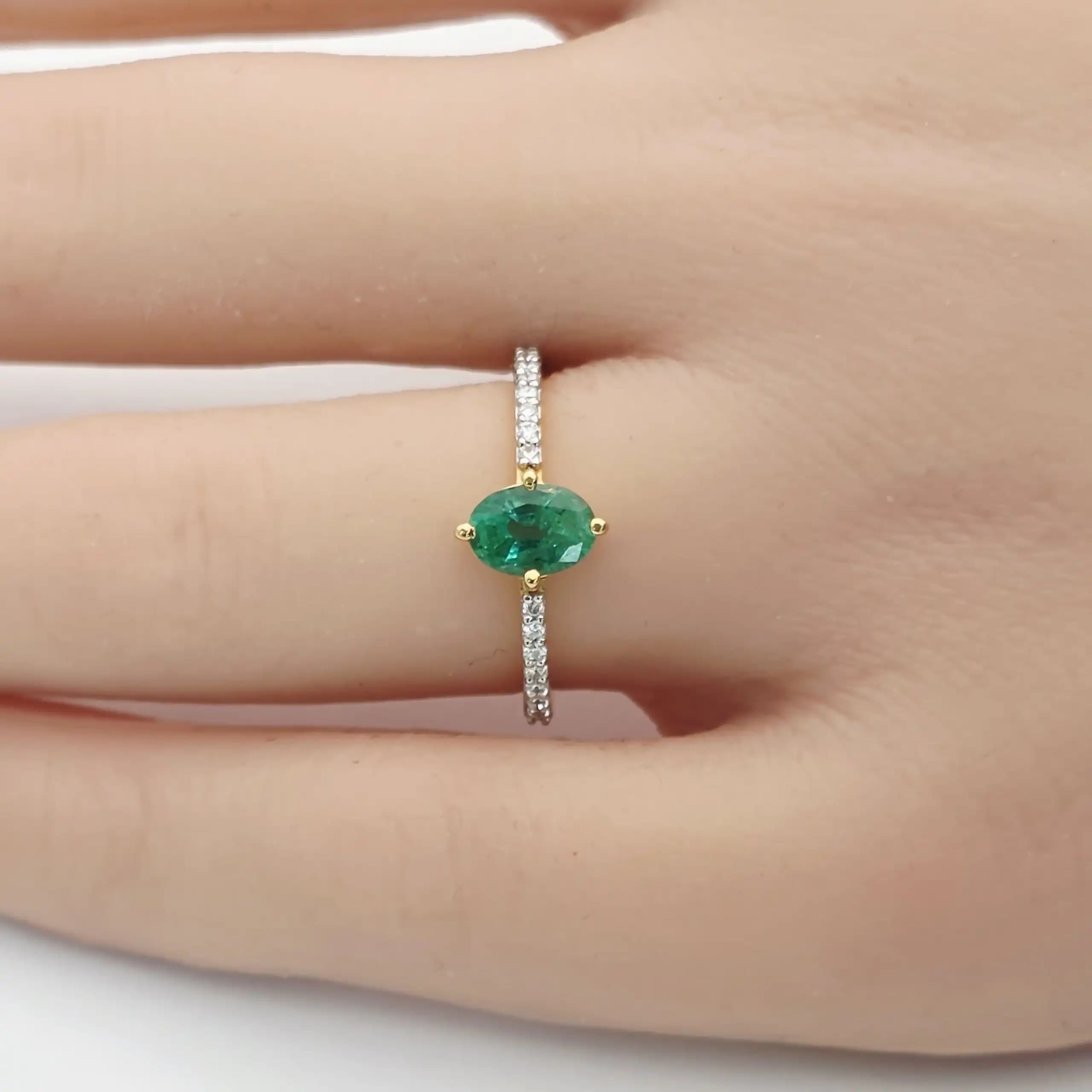 0.64 cts oval natural emerald solitaire ring in 18K yellow gold