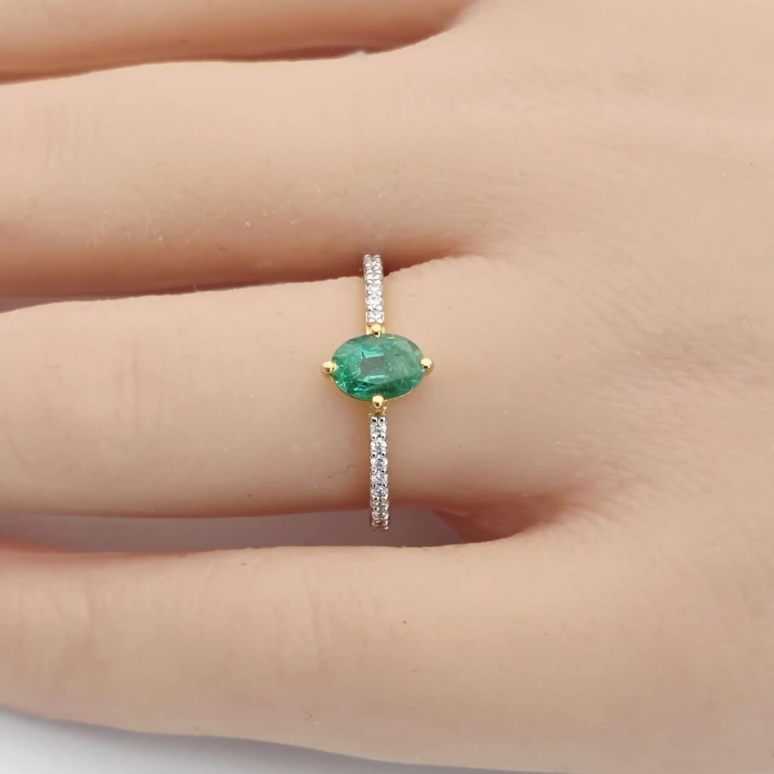 0.64 cts oval natural emerald solitaire ring in 18K yellow gold