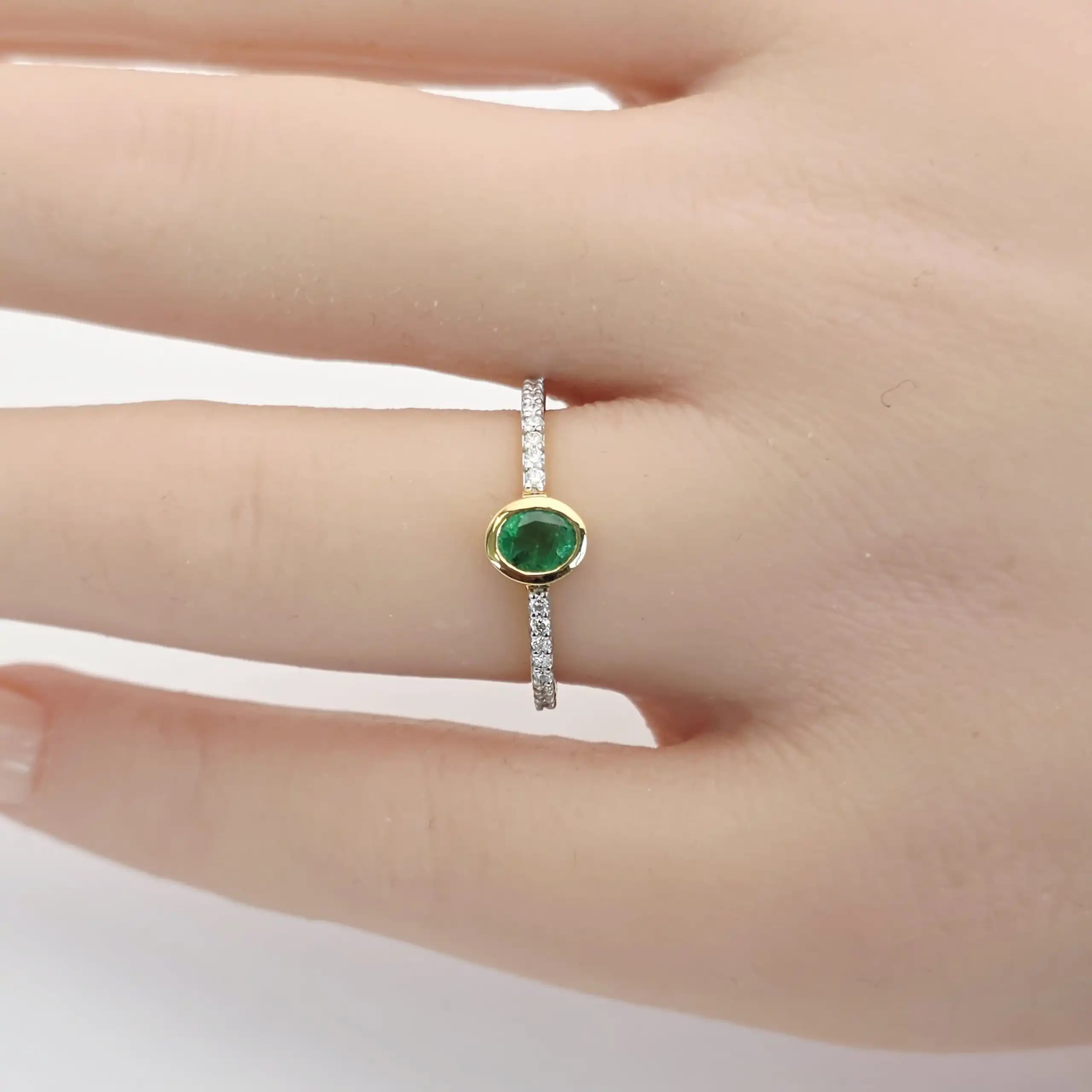 0.31 cts oval natural emerald bezel ring in 18K yellow gold